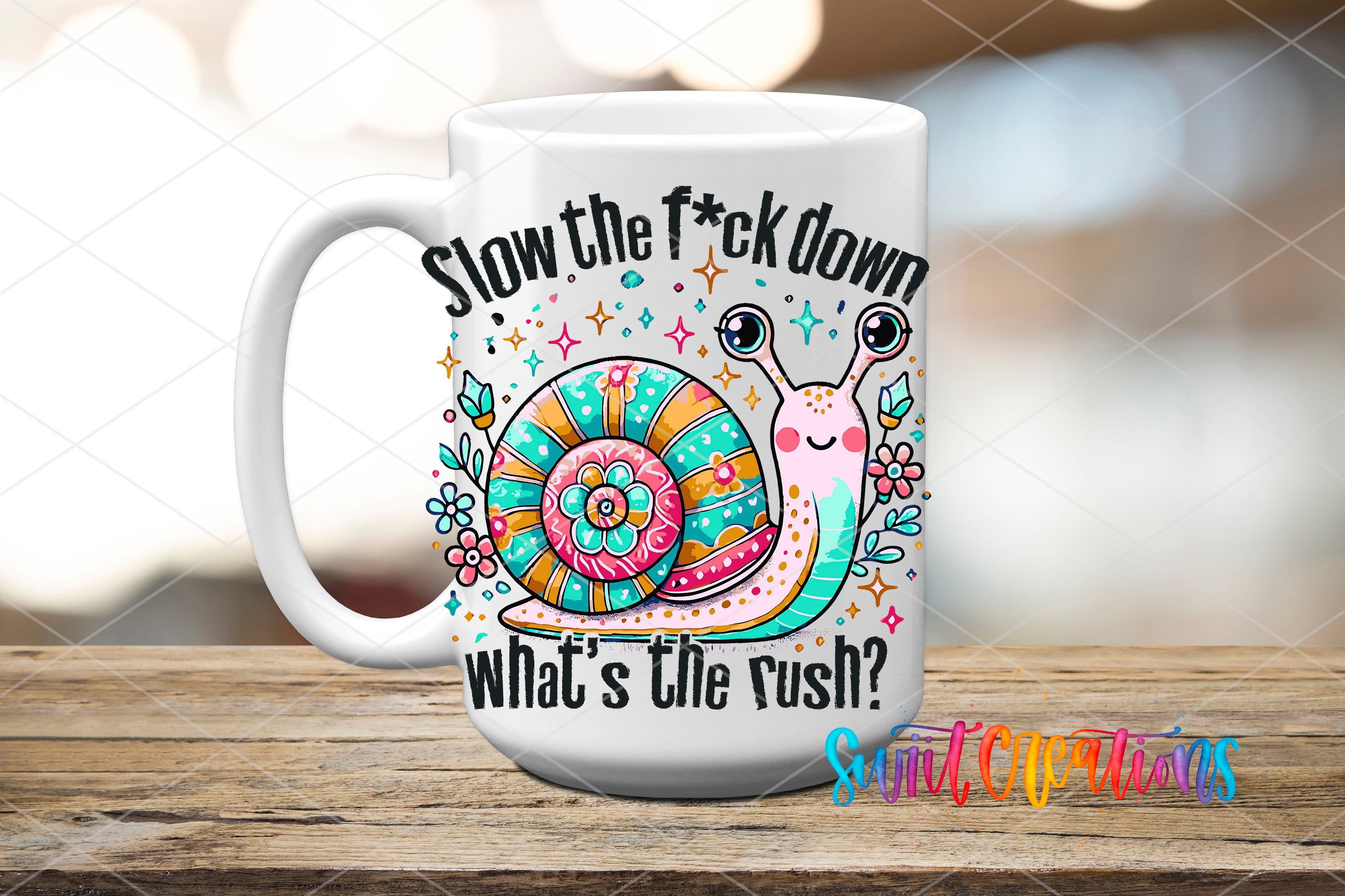 A white ceramic mug with a colorful design featuring a snail and the text "Slow the fuck down, what's the rush?"