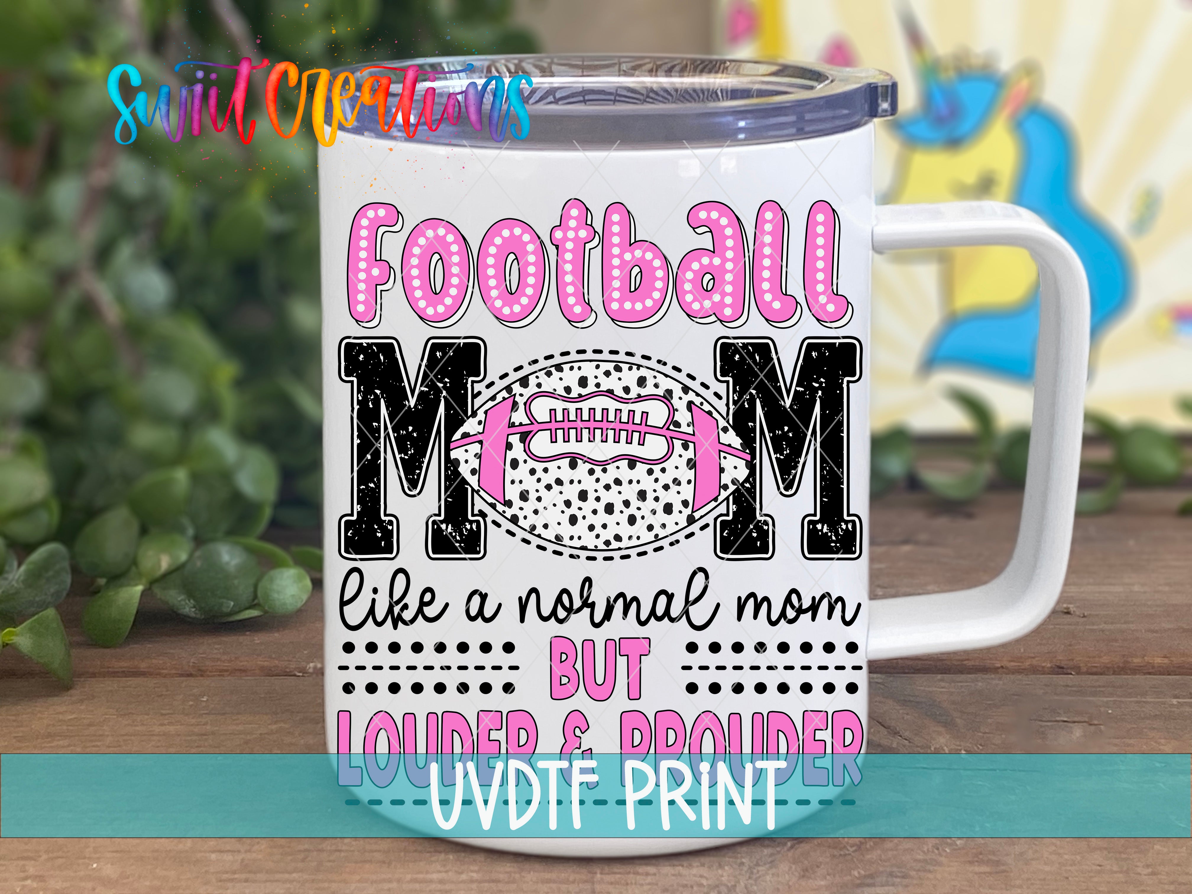 A white mug with a printed design that says "Football Mom" in pink and black text, along with a football graphic and additional text that reads "like a normal mom but louder & prouder".