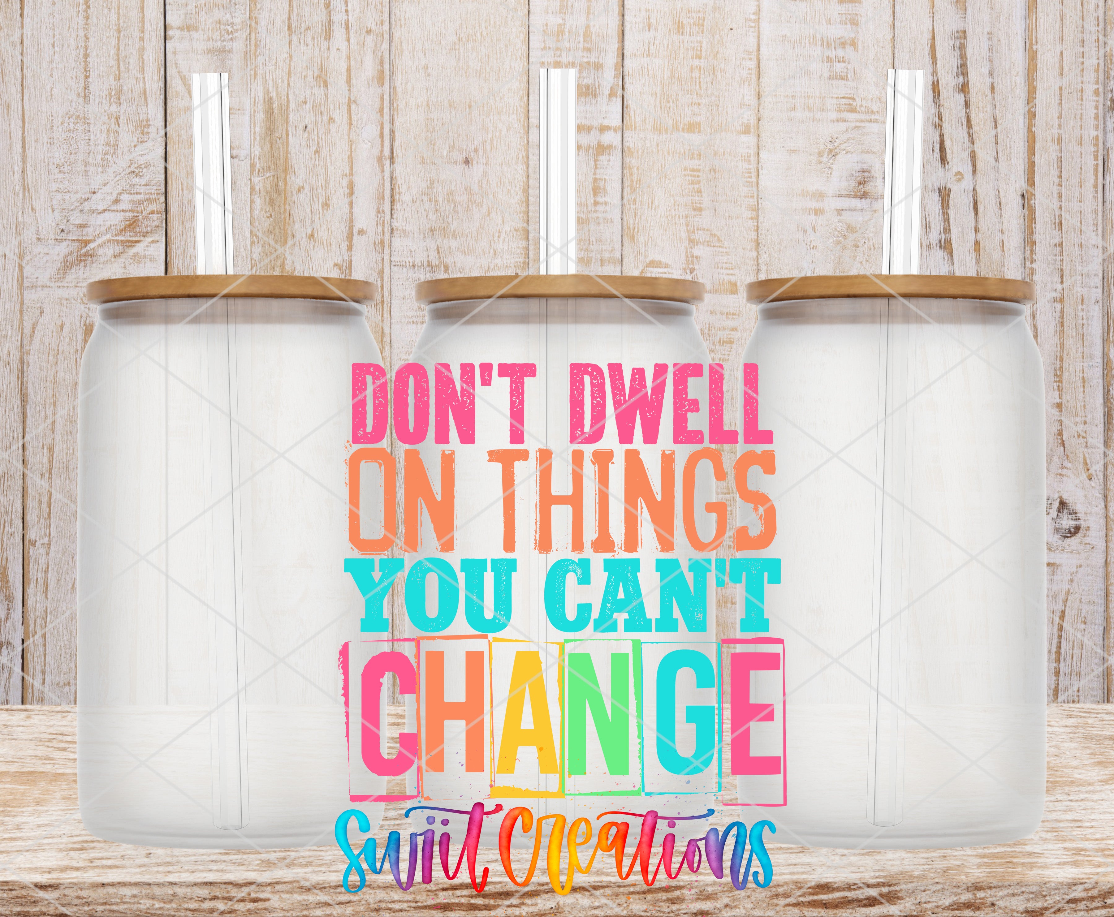 three transparent glass jars with lids, arranged in a row against a wooden background. The text "DON'T DWELL ON THINGS YOU CAN'T CHANGE" is displayed prominently in the center of the image.
