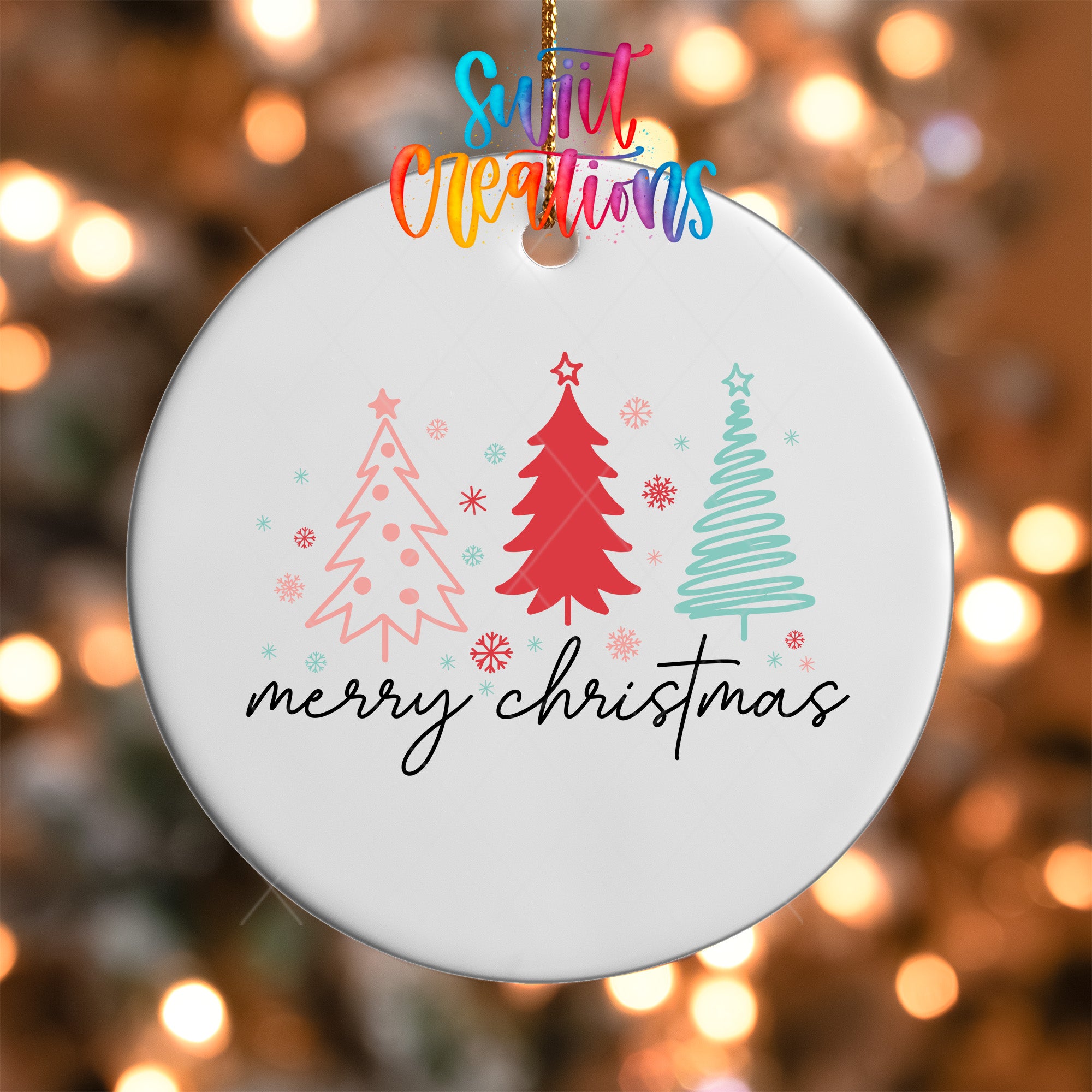 A white Christmas ornament with a festive design featuring three stylized Christmas trees and snowflakes. The text "Merry Christmas" is written below the ornament.