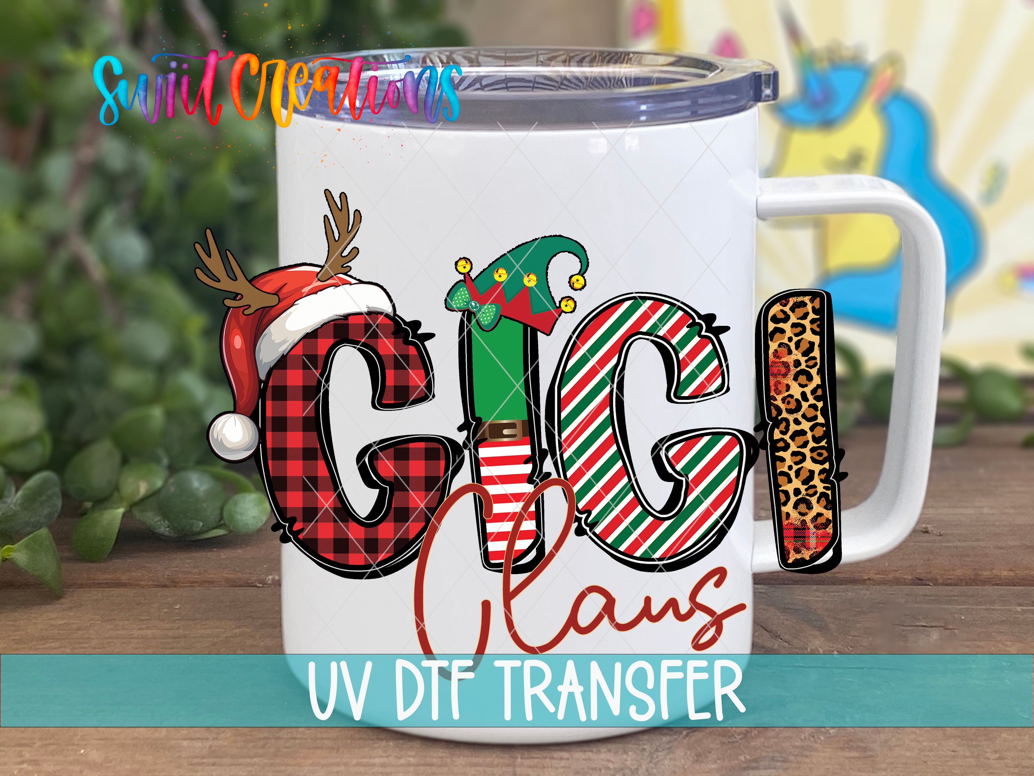 A white mug with a colorful design featuring a Santa hat, reindeer antlers, and the word "GIGI" in a stylized font.