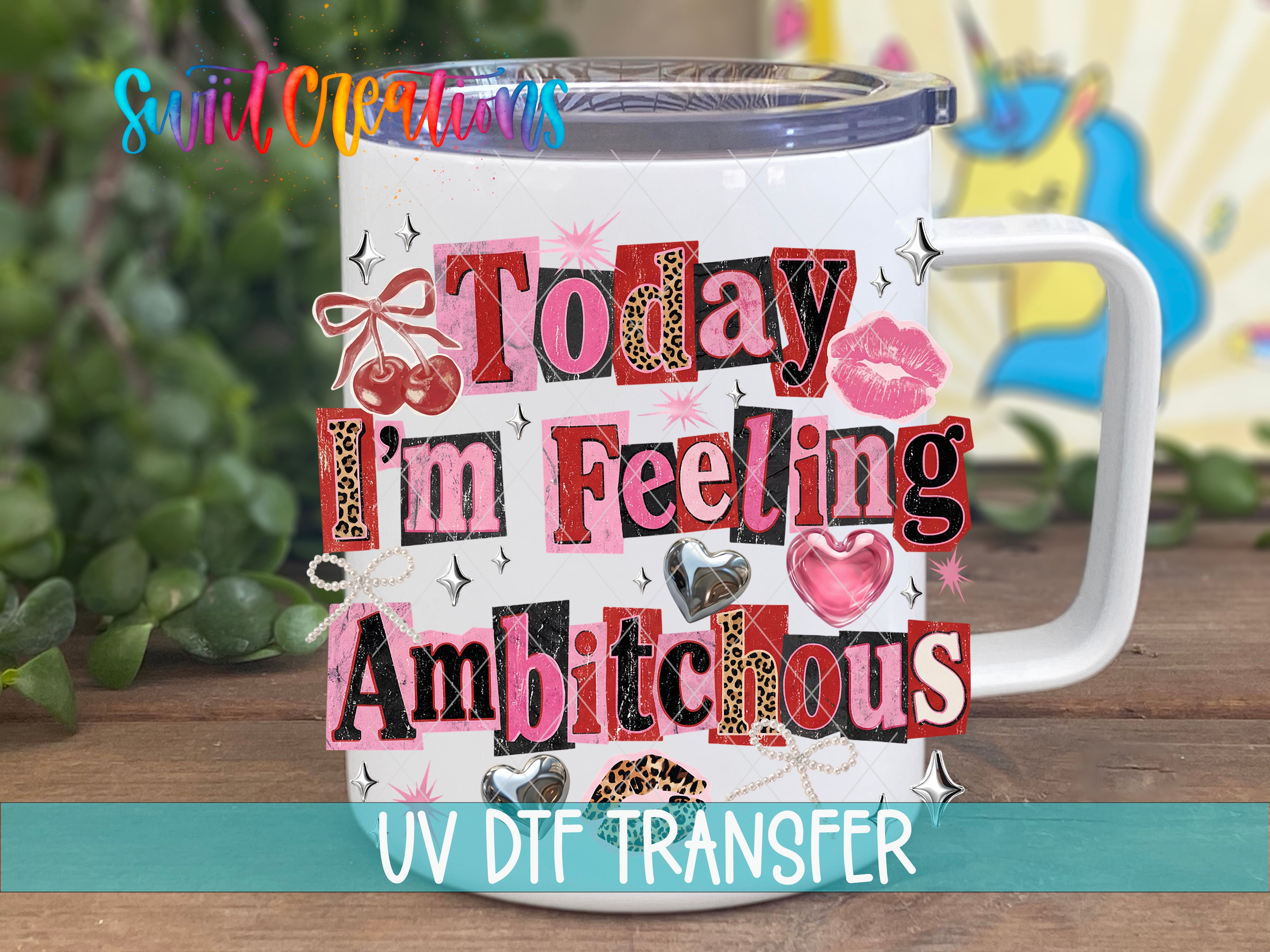 A white mug with a colorful and playful design featuring the text "Today I'm Feeling Ambitious" and various decorative elements such as hearts, stars, and a unicorn.