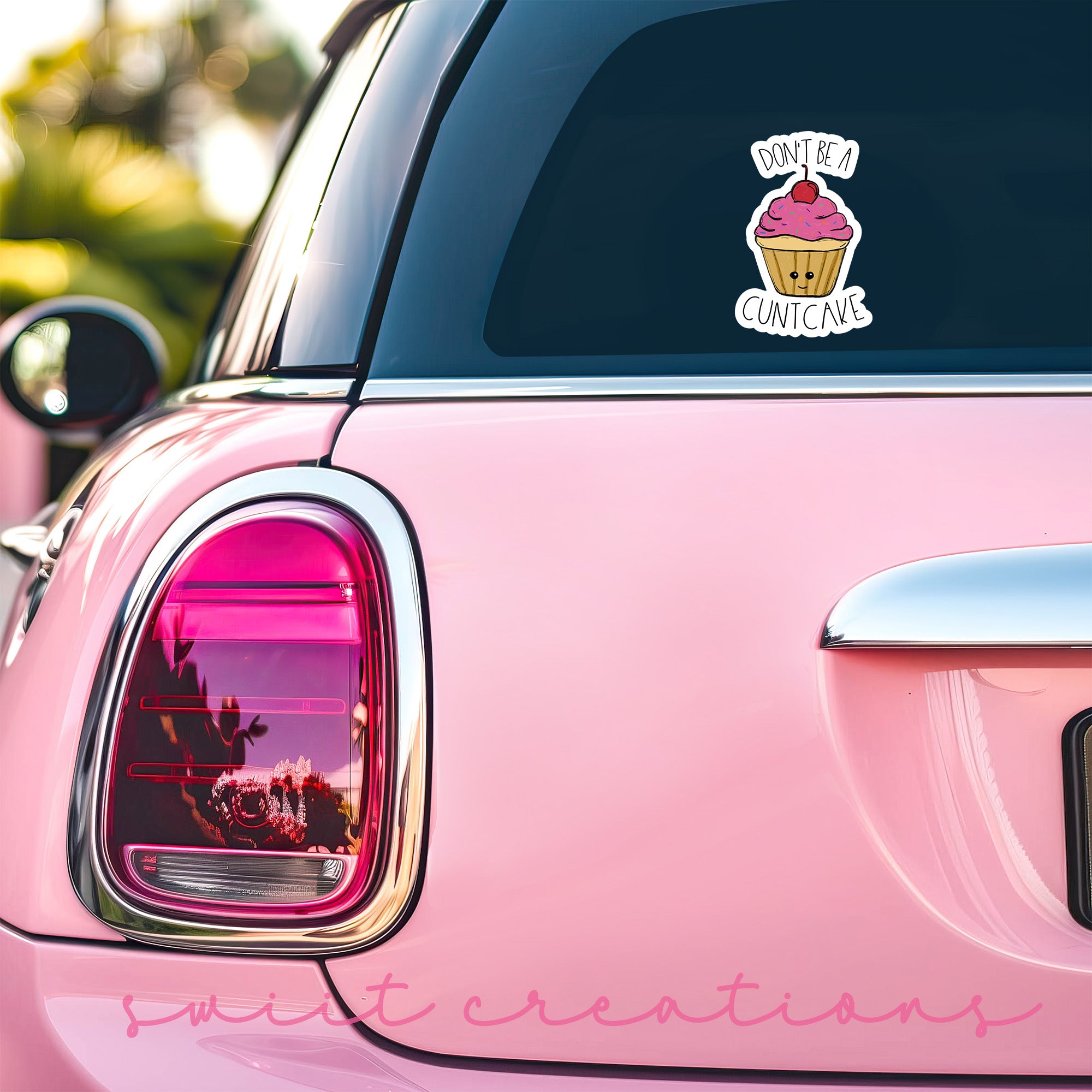 a pink car with a cupcake sticker on it