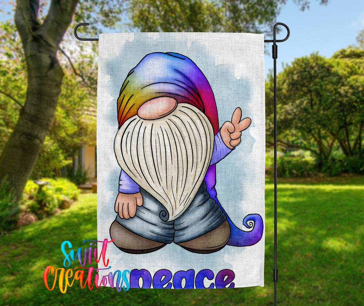 A colorful garden gnome sign with the word "Peace" written below it, set against a backdrop of trees and greenery.