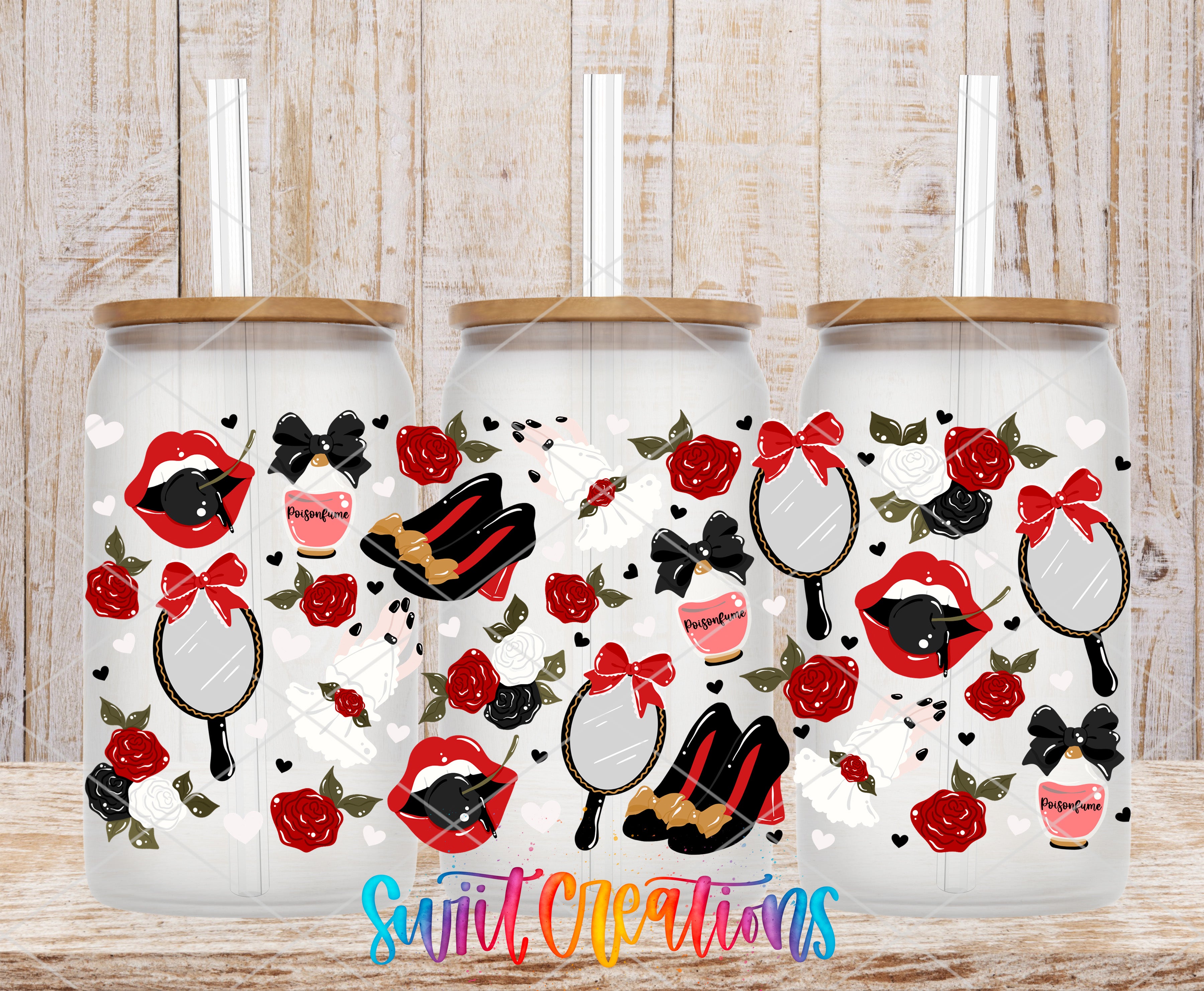 Three glass tumblers with a floral and bow motif printed on them, placed on a wooden surface.
