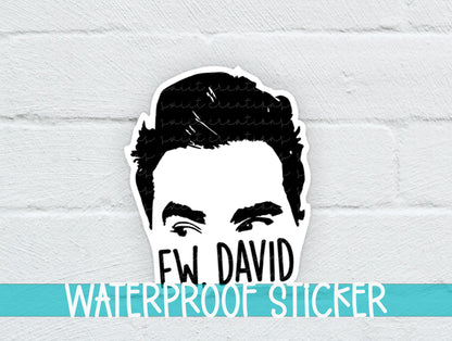 a sticker of a man's face on a white brick wall