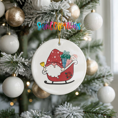 A Christmas tree decorated with ornaments, including a round ornament featuring a Santa Claus figure on a sled.