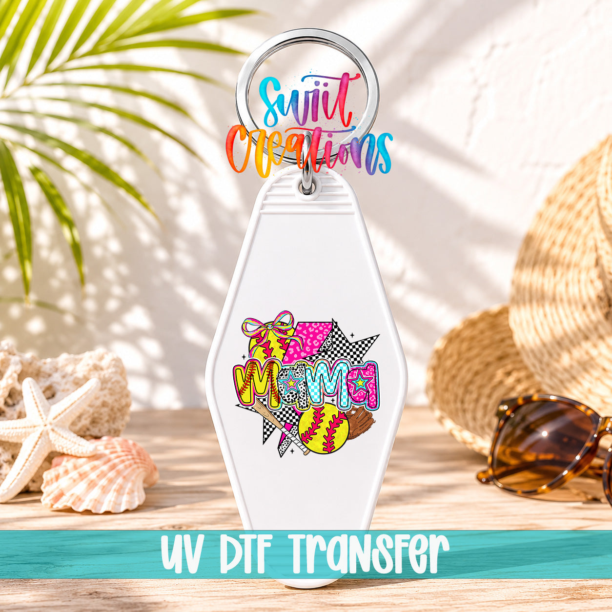 A keychain with a colorful design featuring a palm tree, sunglasses, and a baseball, placed on a wooden surface with a straw hat and seashells in the background.
