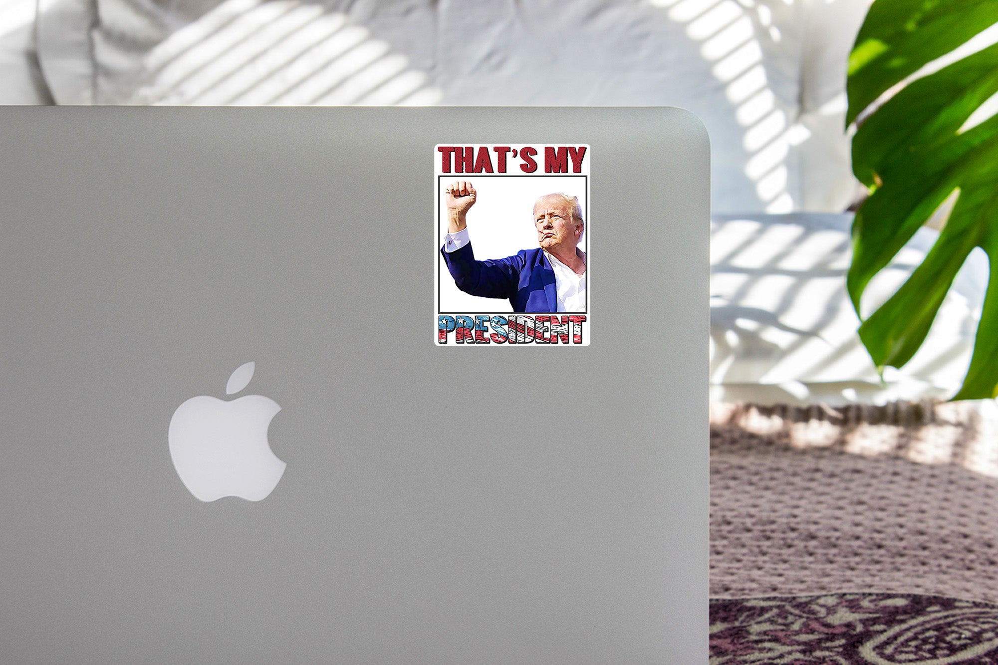 an apple laptop with a sticker on it