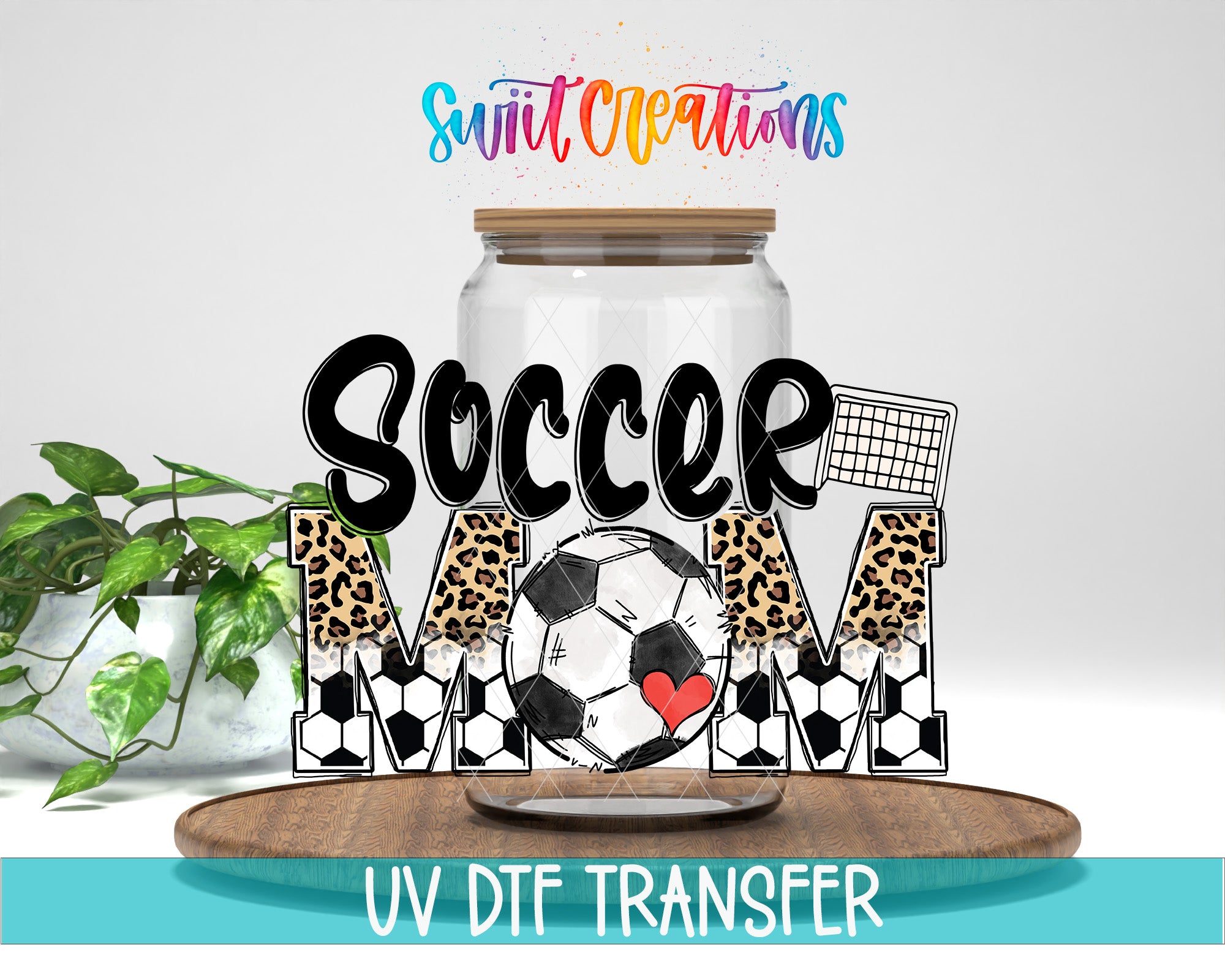 a soccer-themed design with the text "Soccer Mom" and a soccer ball graphic. The design is displayed on a wooden tray, and there is a jar with a lid on it. The background is white, and there is a plant in the background.