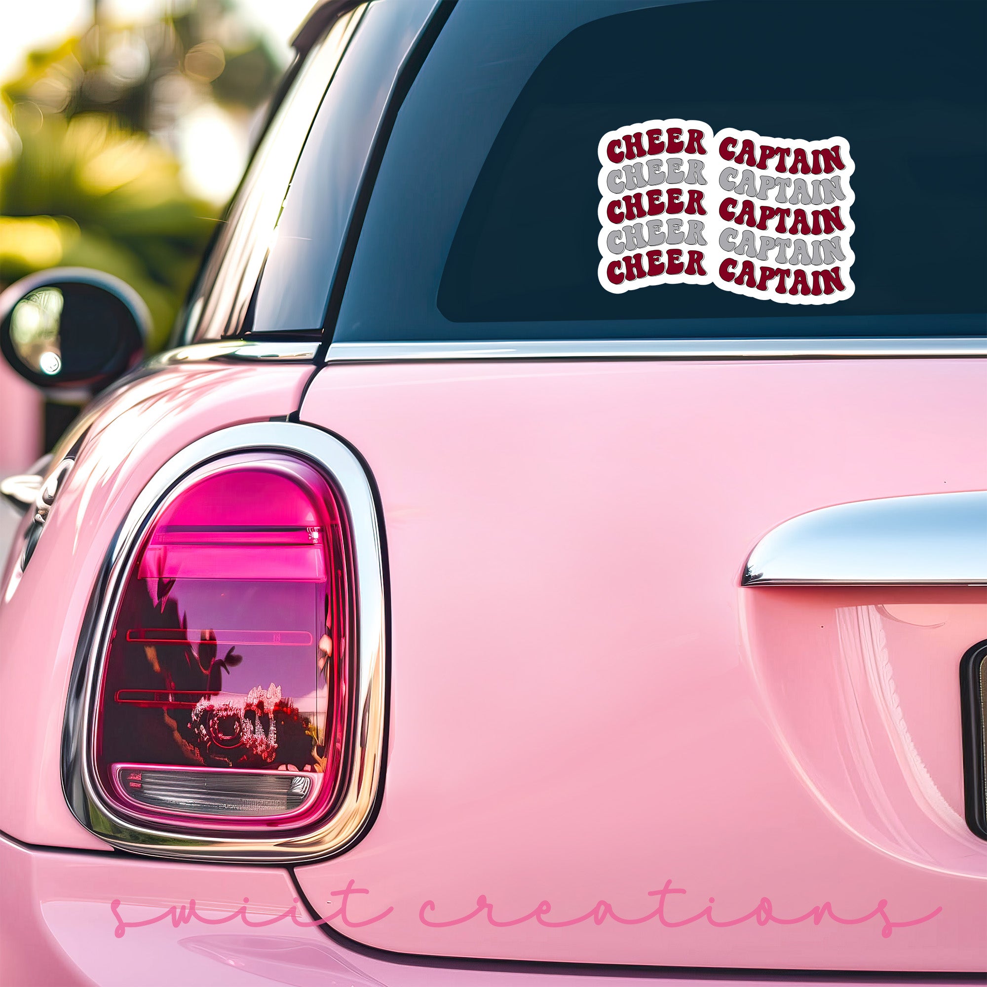 a pink car with a sticker on the back of it