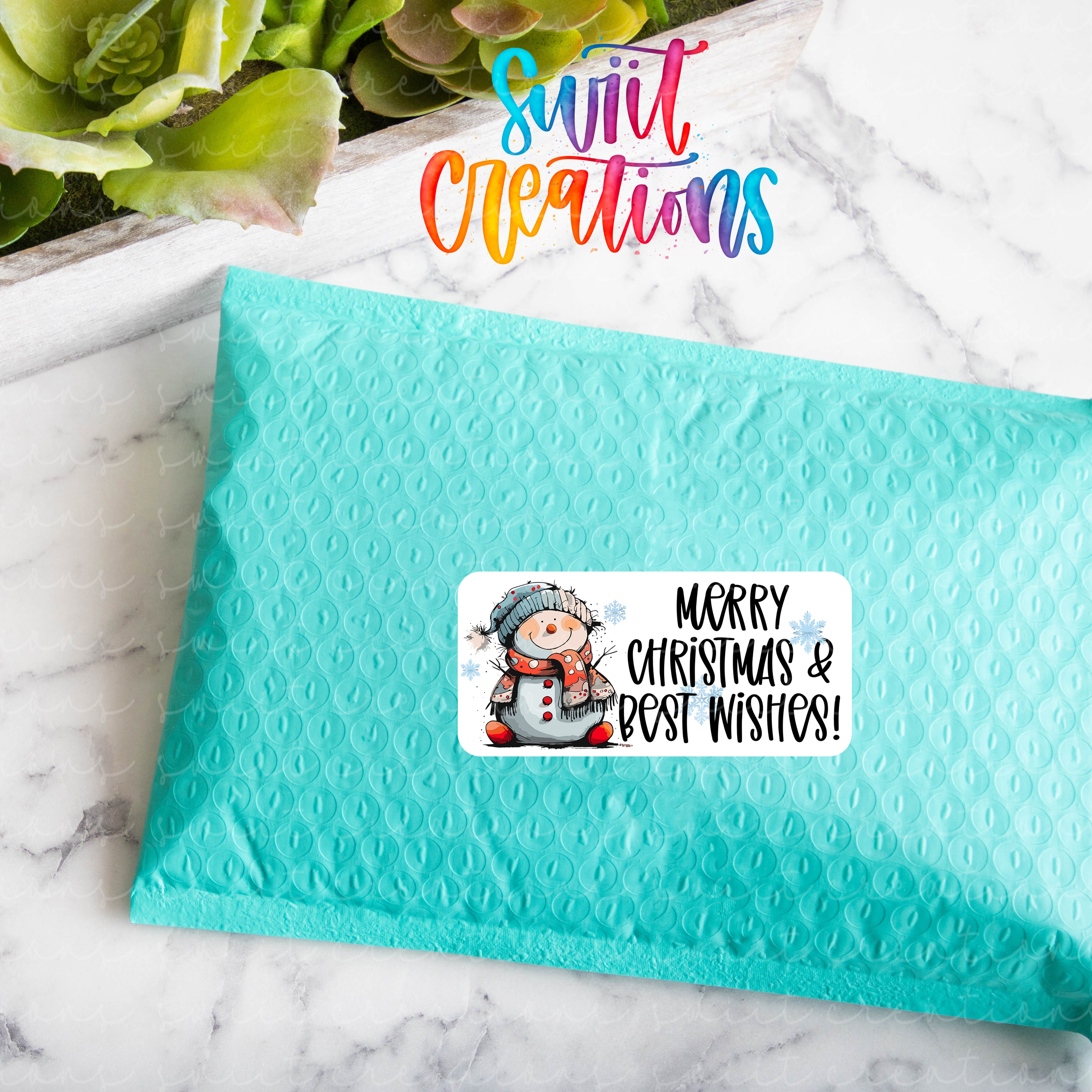 a blue envelope with a sticker of a snowman on it