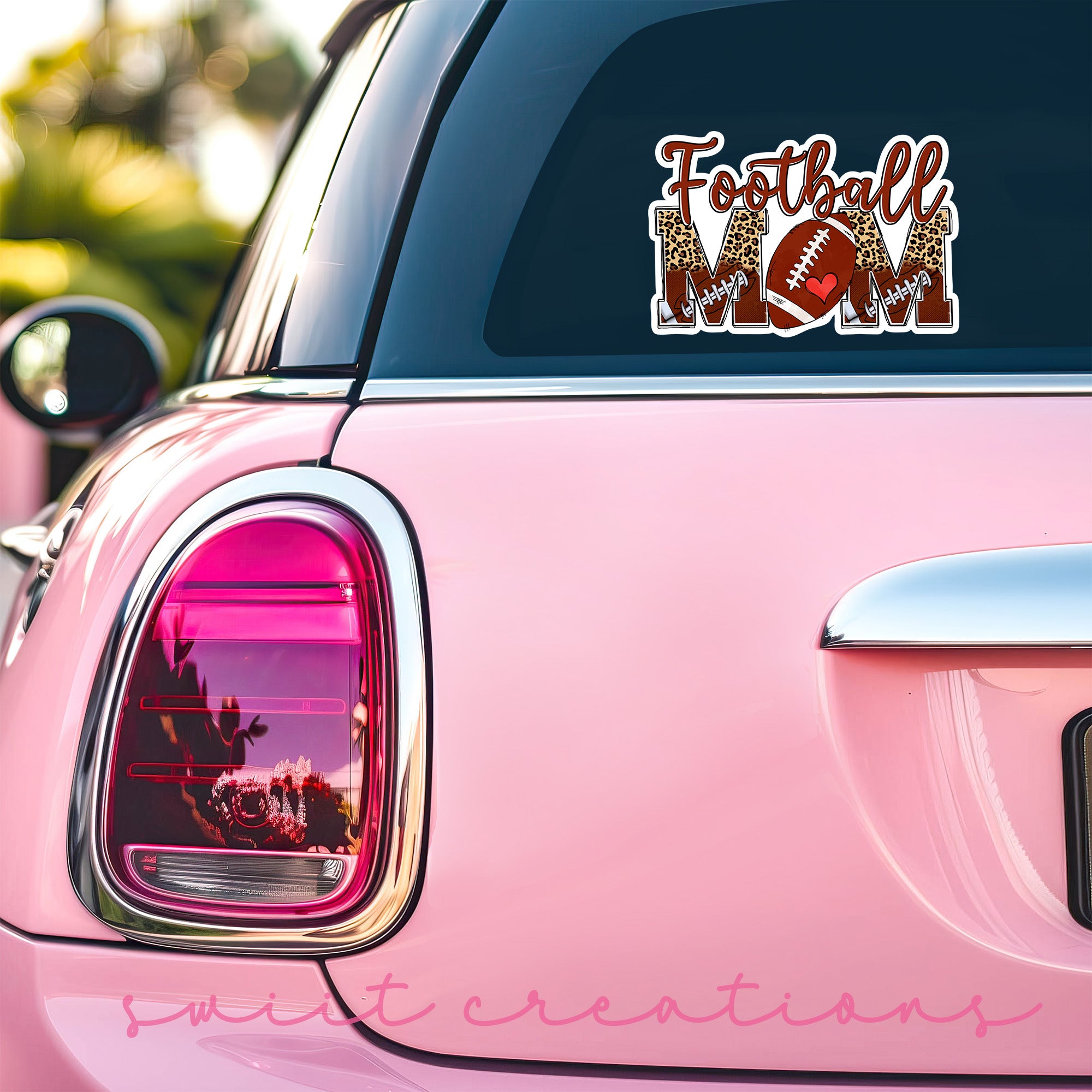a pink car with a football sticker on it
