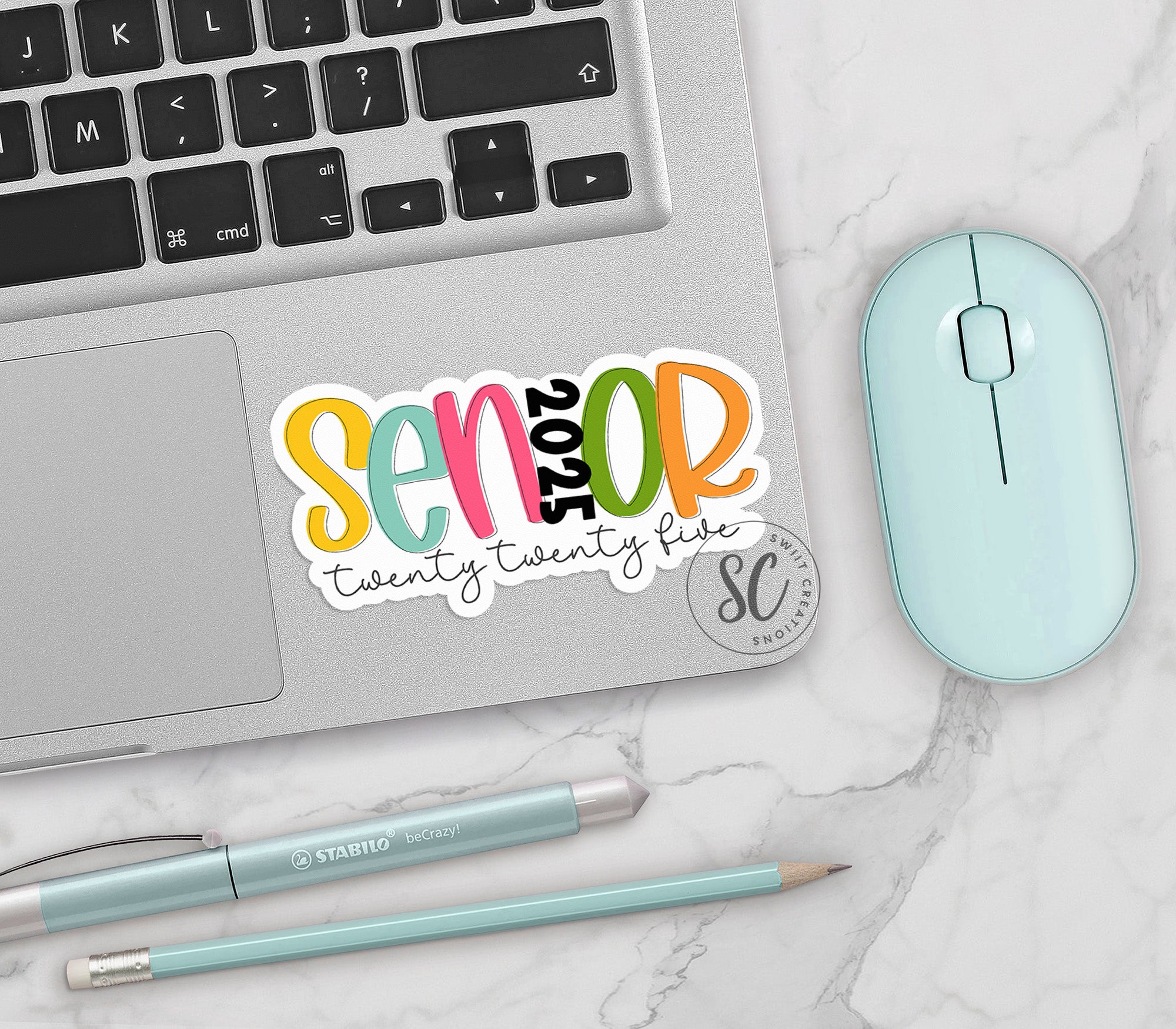 a laptop computer sitting on top of a desk next to a mouse