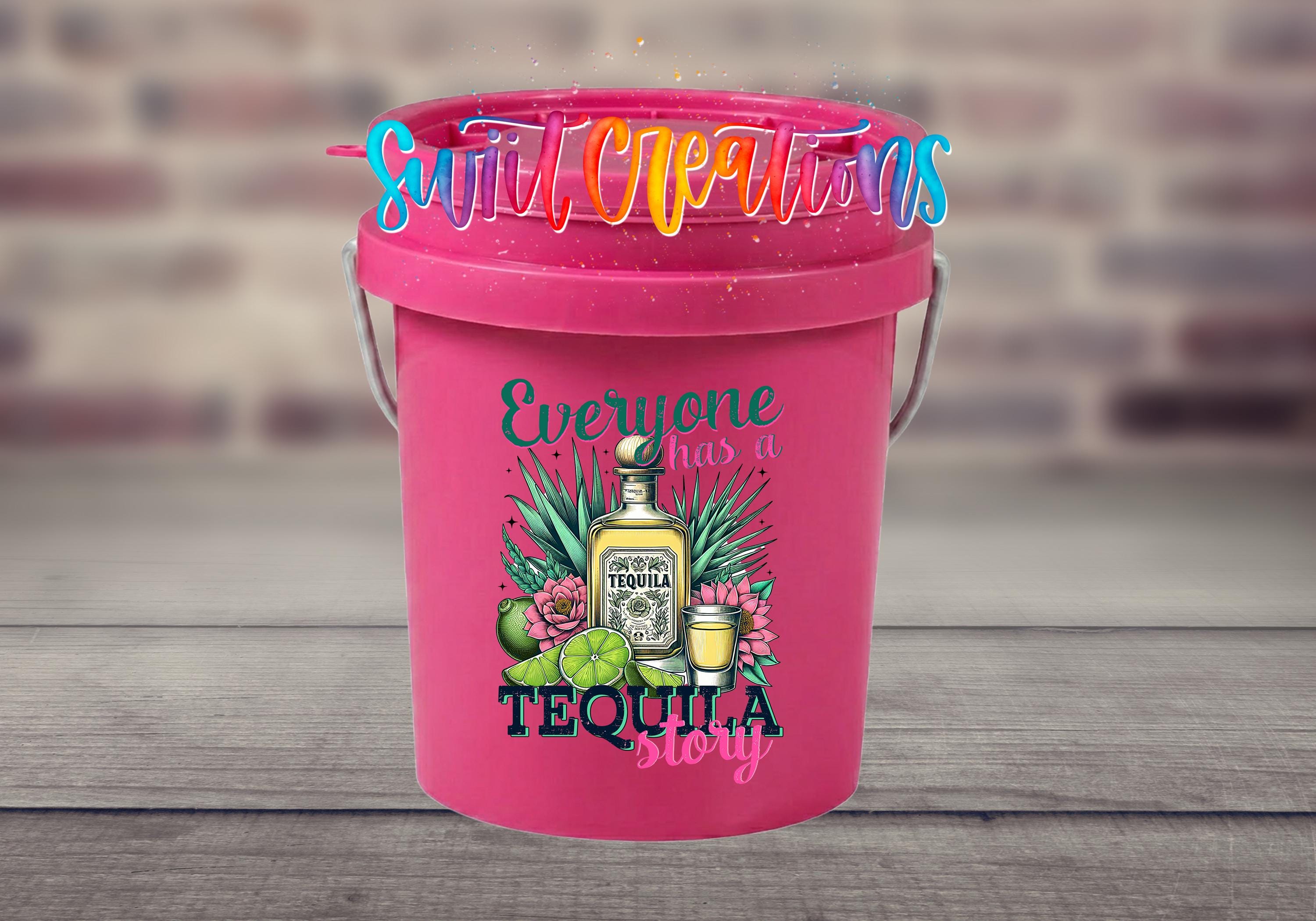 A pink bucket with a tequila-themed design, featuring a bottle of tequila, a lime, and a flower, along with the text "Everyone has a tequila story".