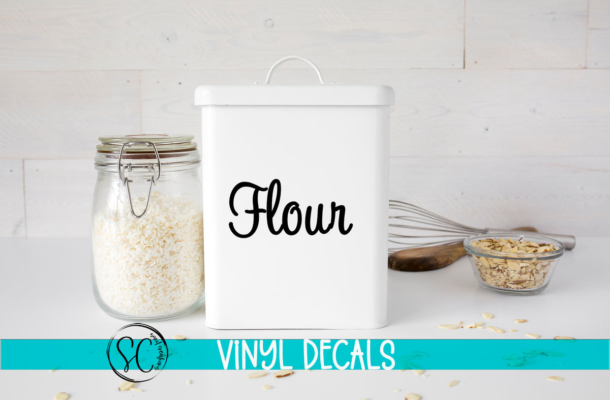 a white canister with the word flour next to it