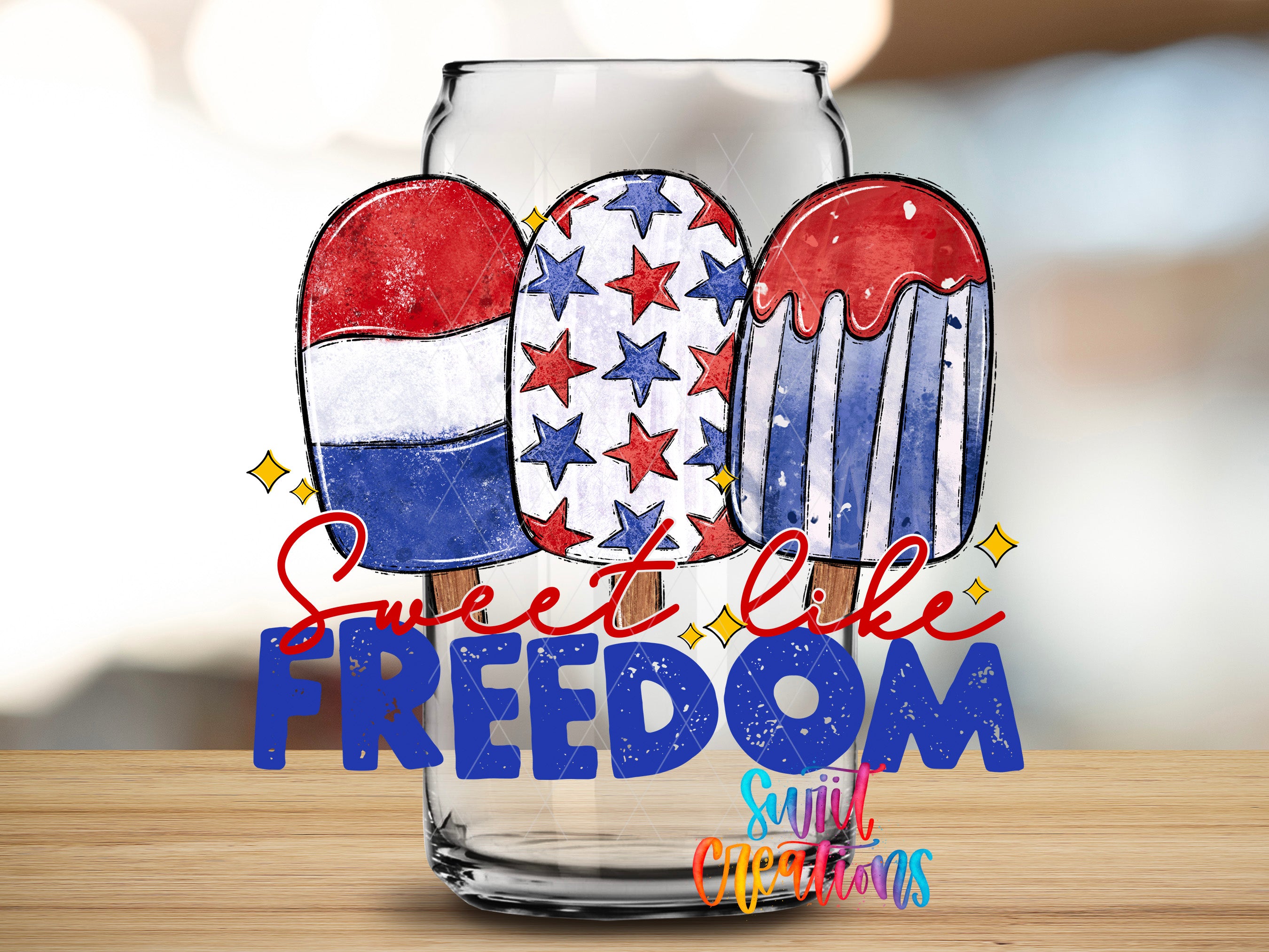 a glass with three colorful popsicles, each with a different design, and the text "Sweet like freedom" written below them.