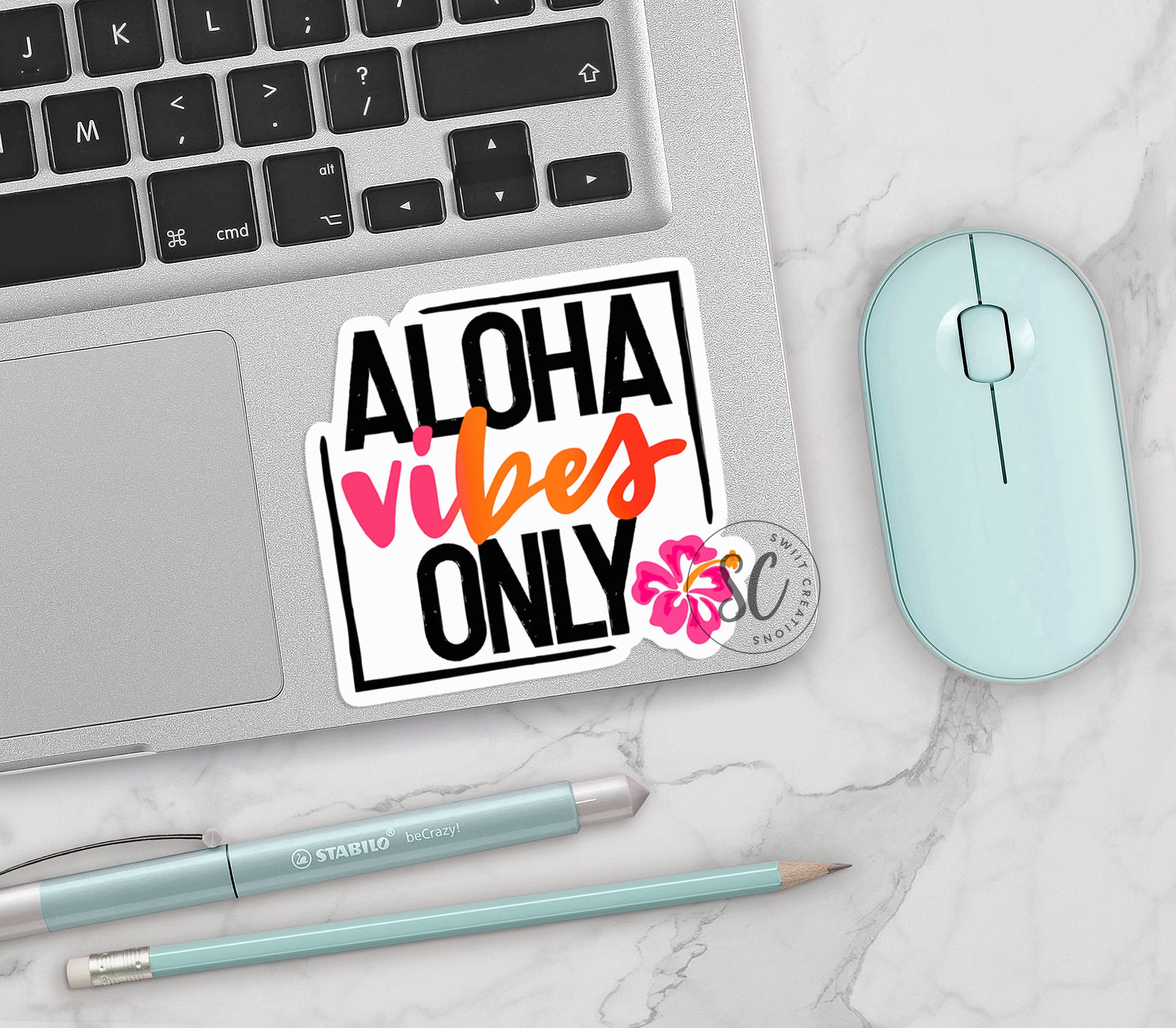 a sticker that says aloh vibes only next to a mouse