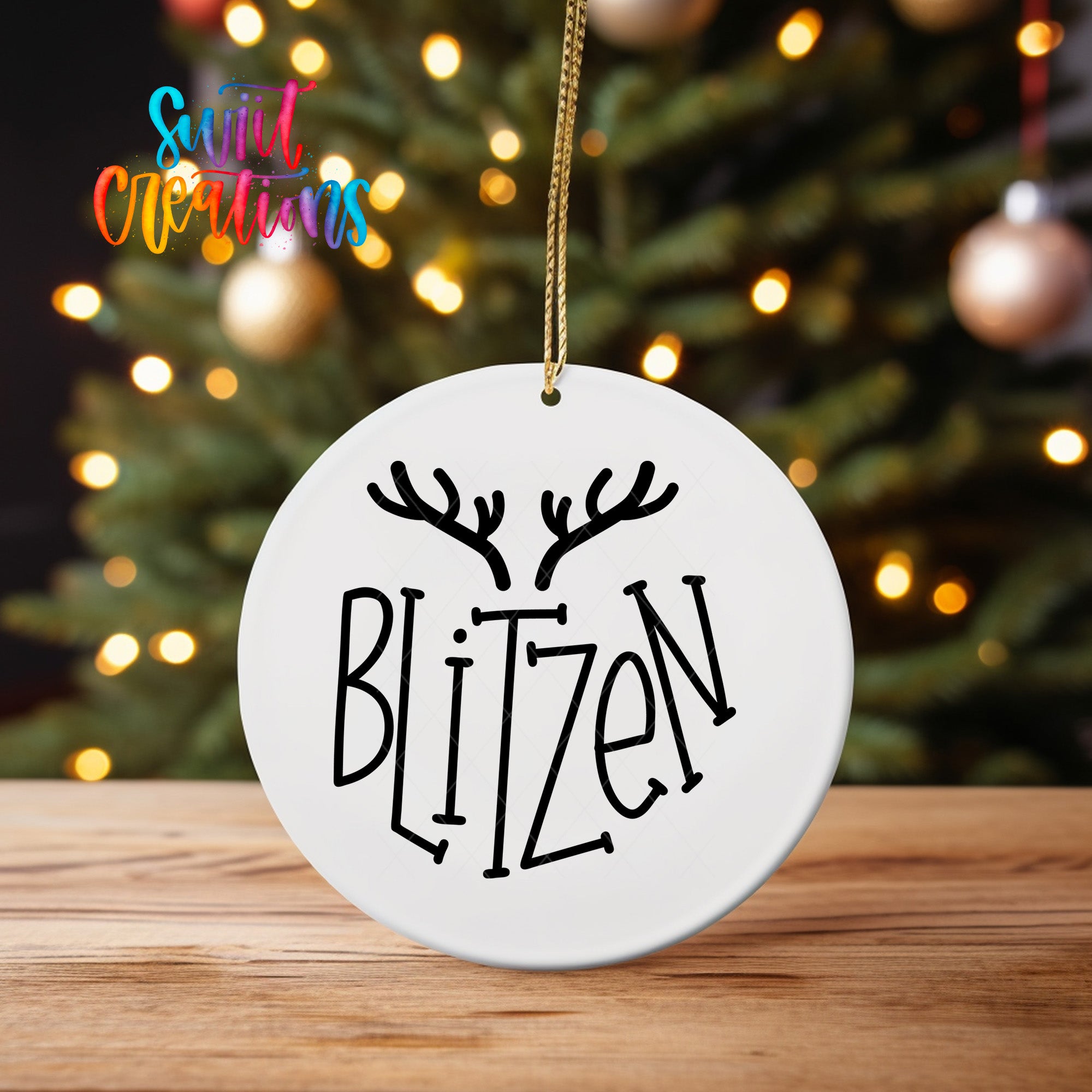 A white ornament with the word "BLIZZEN" written on it, hanging from a string.