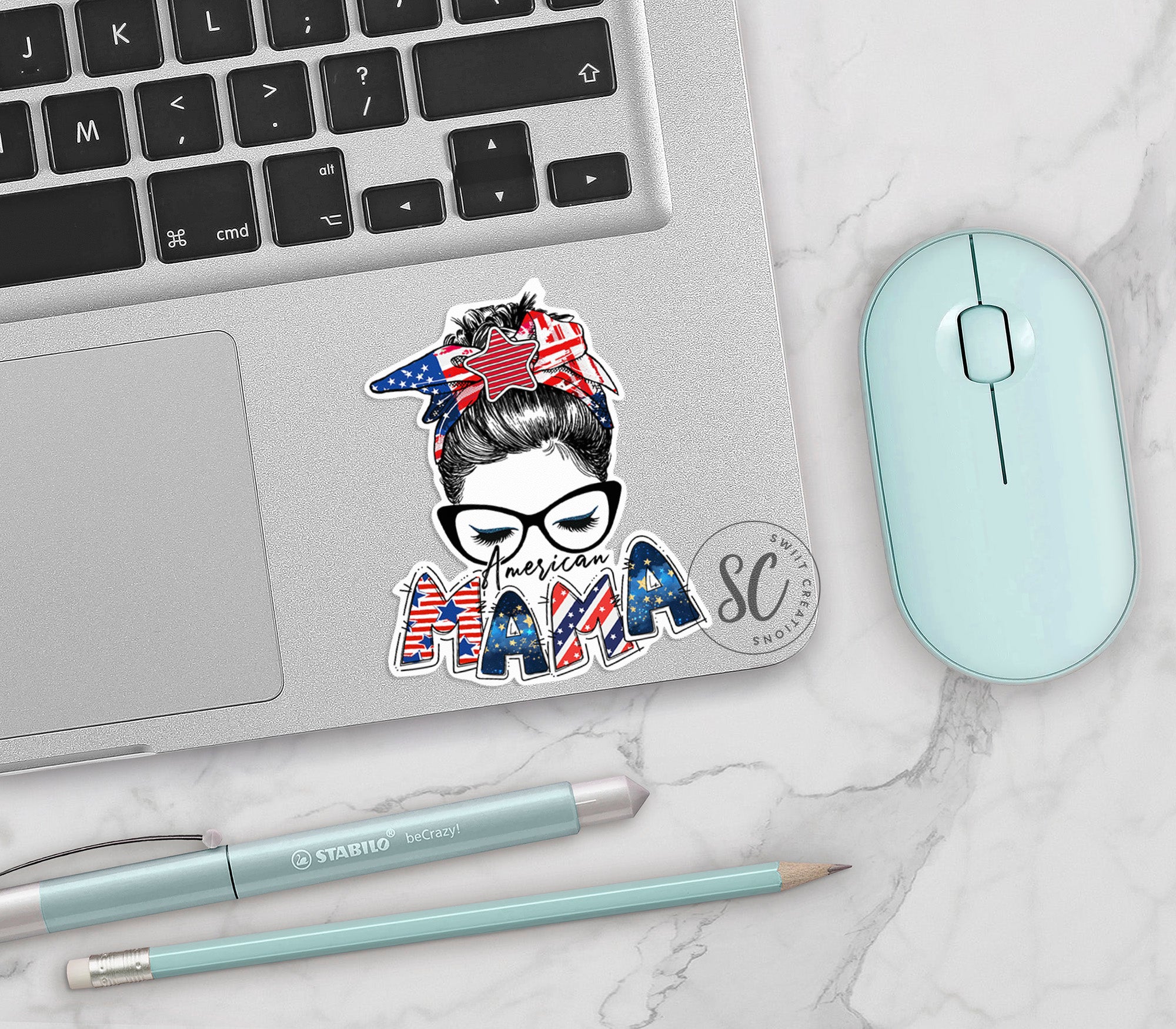 a laptop with a sticker of a woman's face on it