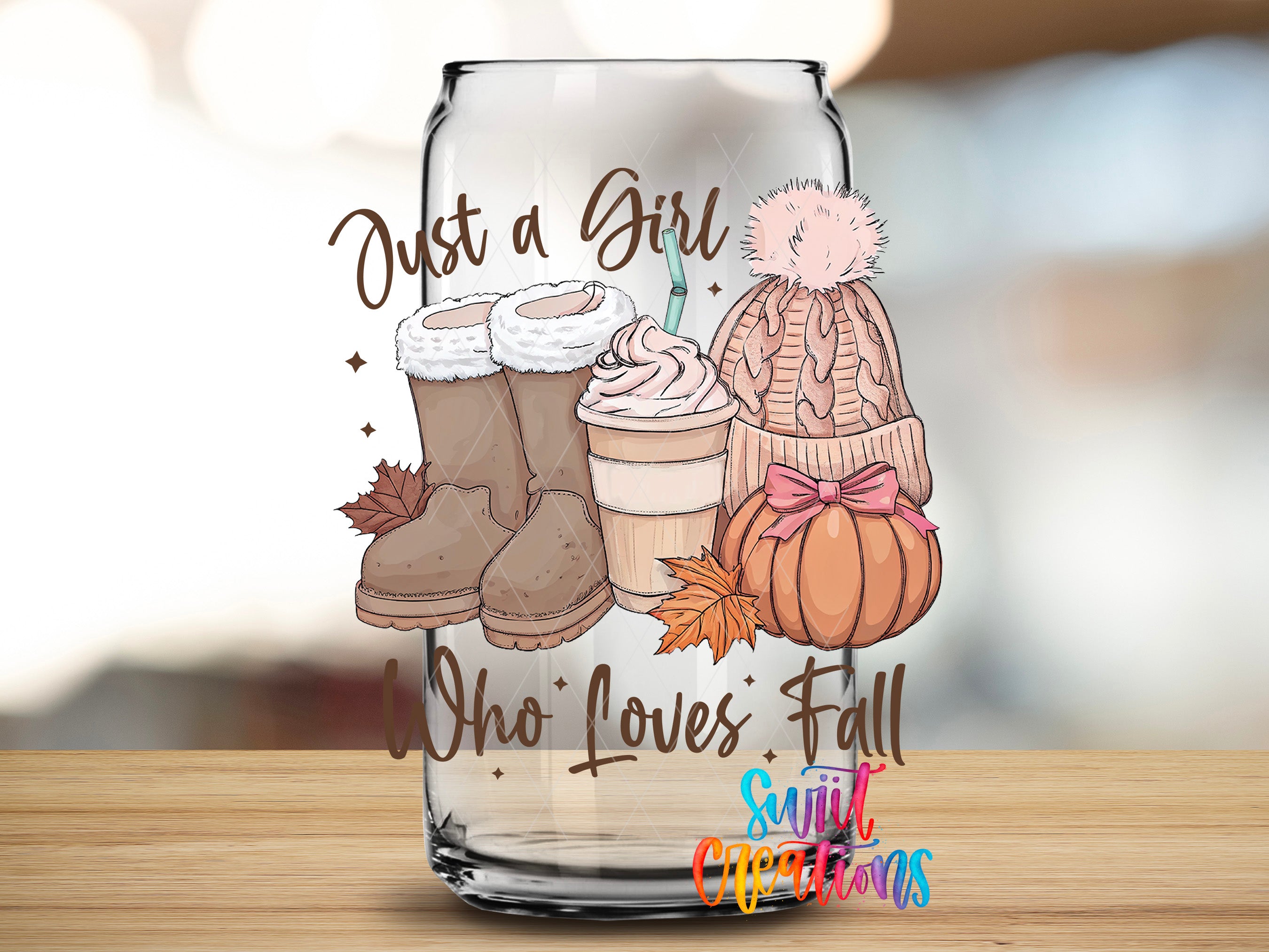 A glass jar with a design featuring winter-themed items such as boots, a hat, a cup of coffee, and a pumpkin. The text on the jar reads "Just a Girl Who Loves Fall" and "Sunlit Christmas".