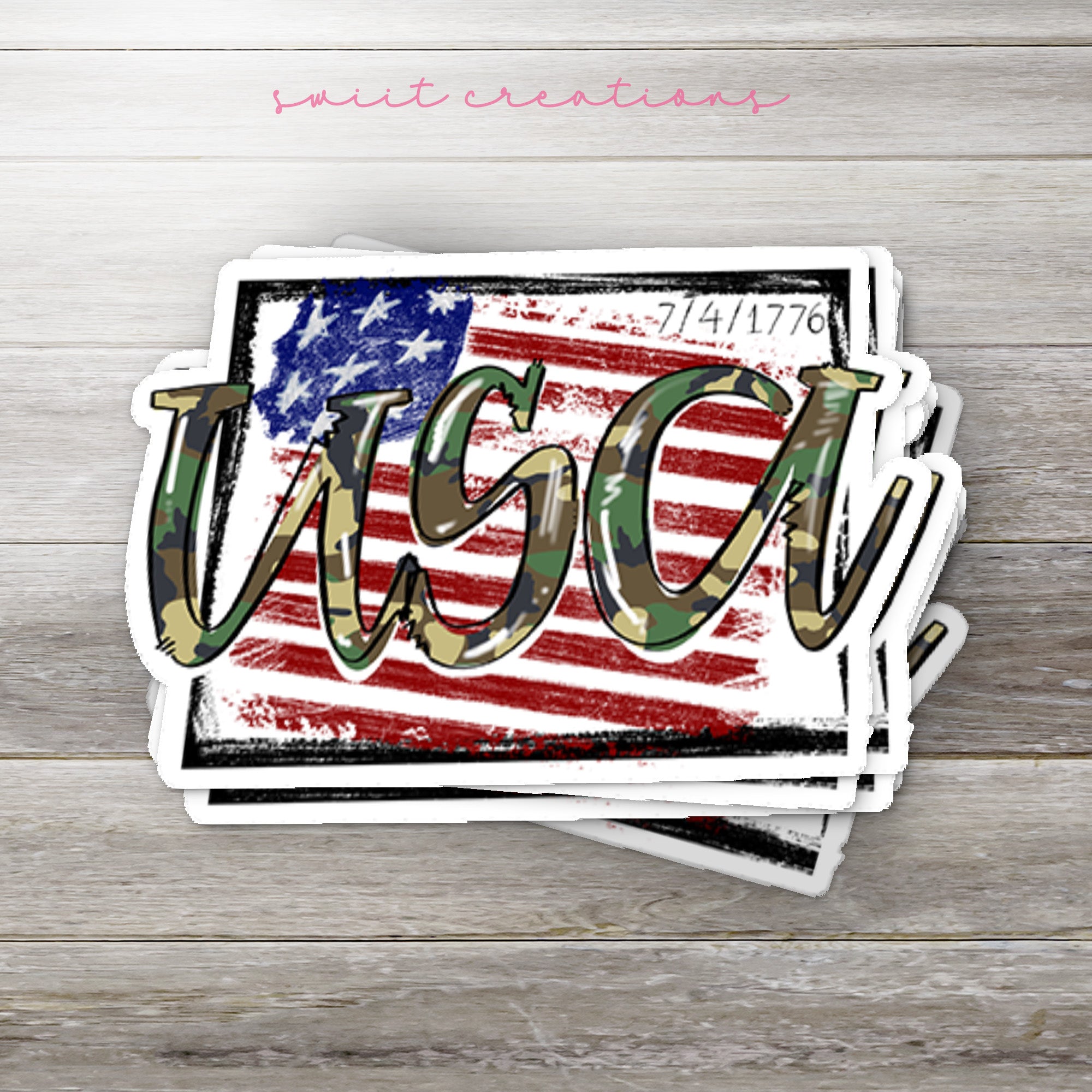 a wooden table topped with stickers and a cell phone