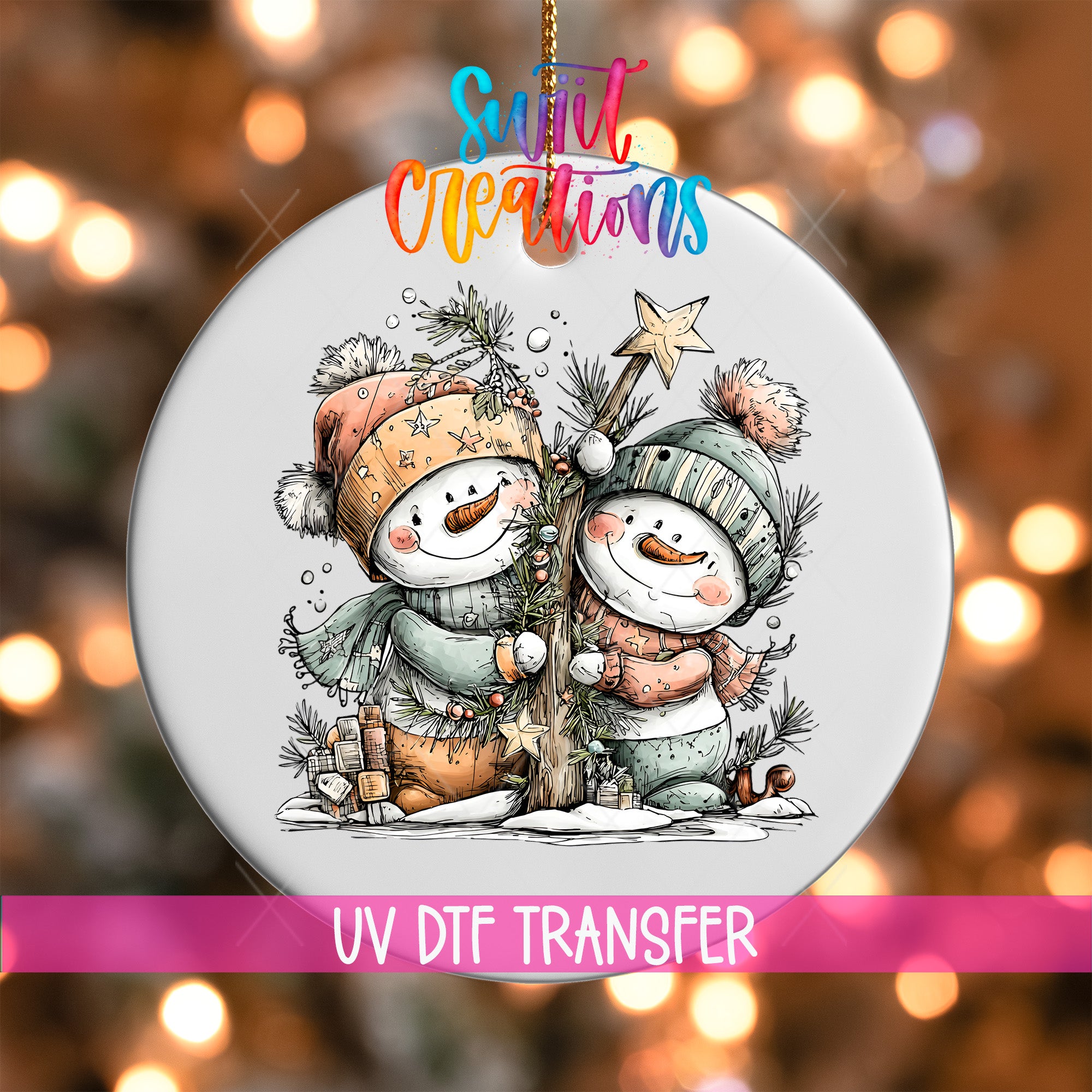 A snowman ornament with two snowmen, one wearing a green hat and the other wearing a pink hat, holding a star and standing next to a tree. The ornament is hanging from a string, and there is a pink ribbon with text that says "UV Dtf Transfer".