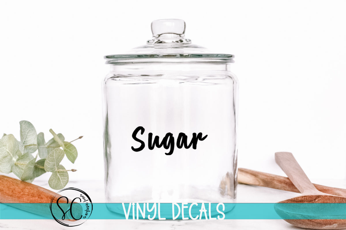 a glass jar with the word sugar on it