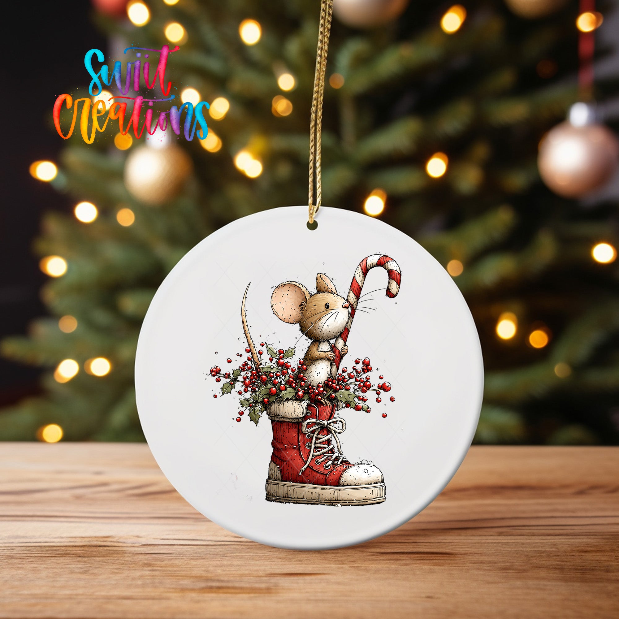 A white oval ornament featuring a cartoon mouse standing in a red shoe, holding a candy cane and surrounded by berries, against a blurred background of Christmas lights.