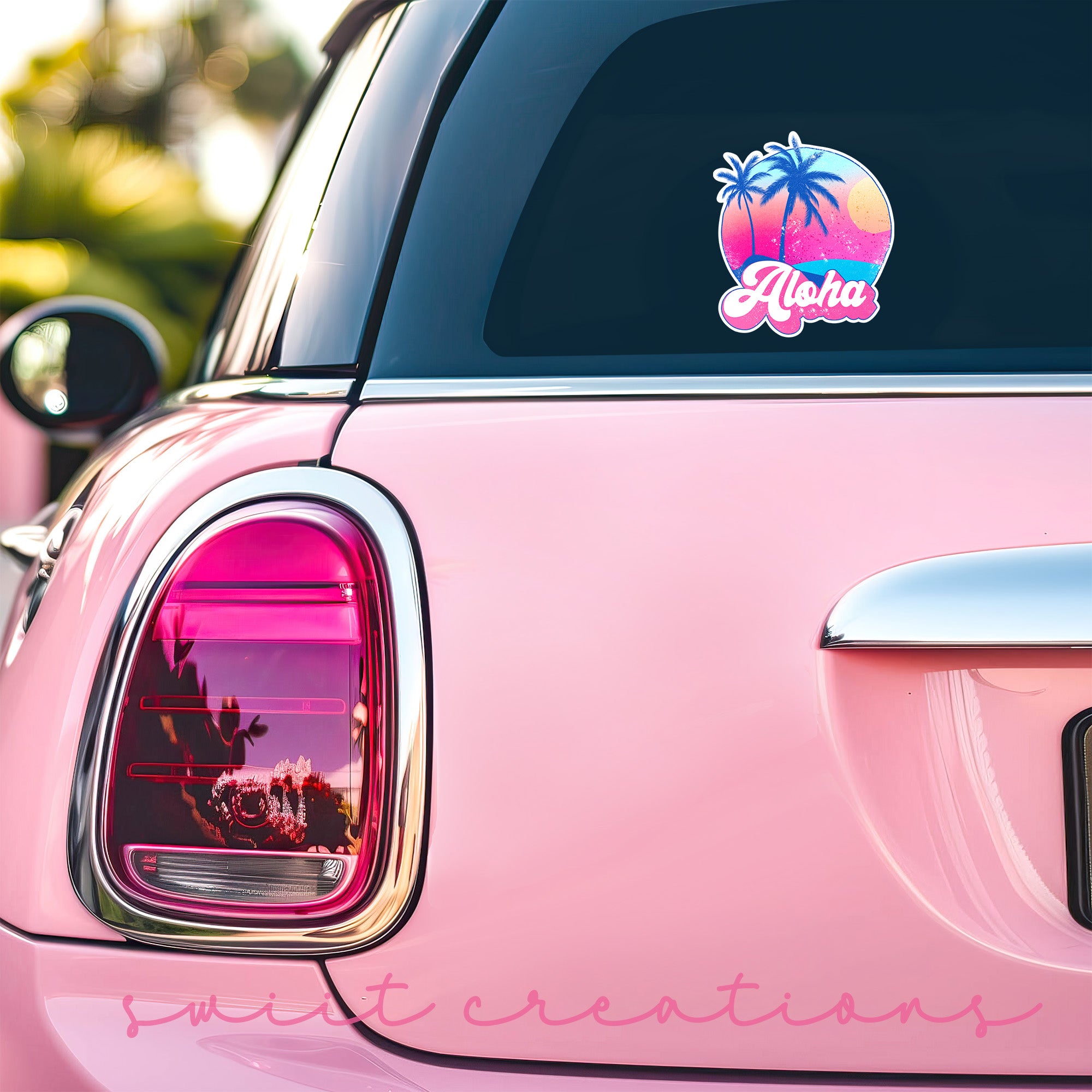 a pink car with a sticker of a palm tree