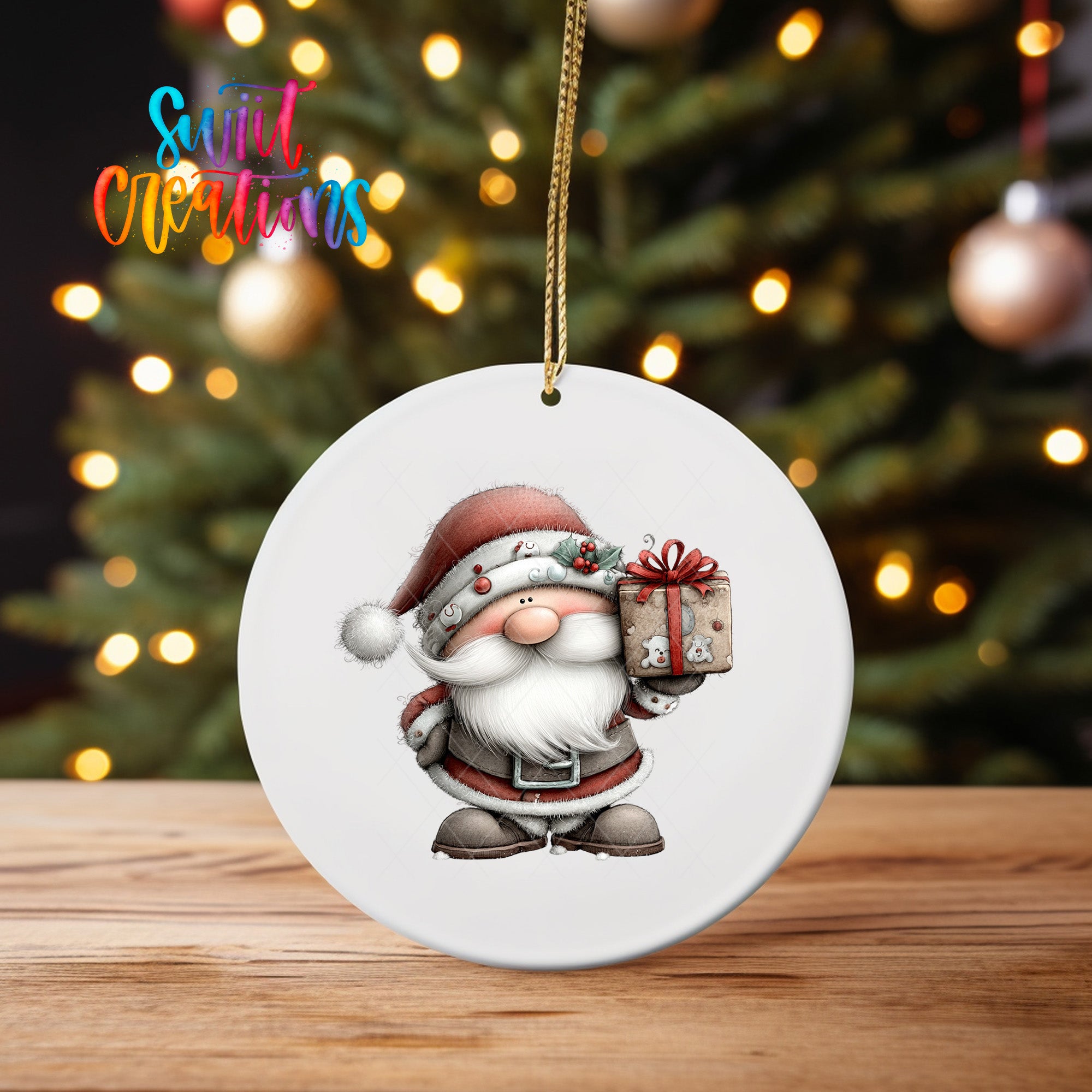 A white oval ornament featuring a cartoon Santa Claus holding a gift box, with a blurred background of a Christmas tree and colorful lights.
