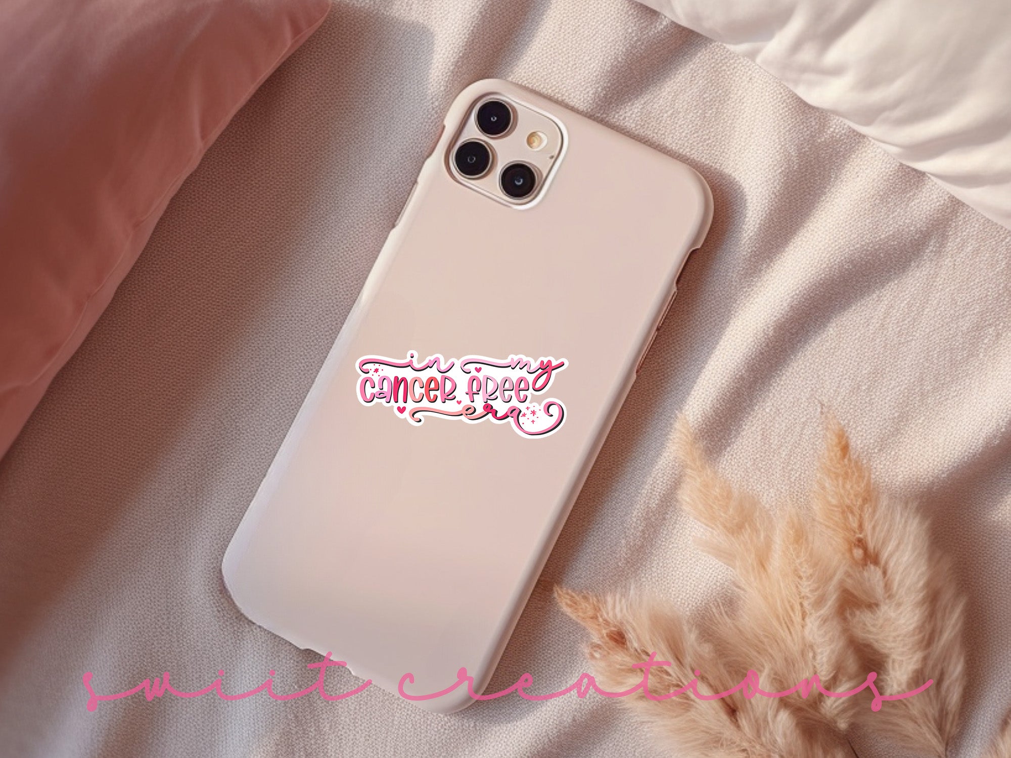 a white phone case with a pink sticker on it