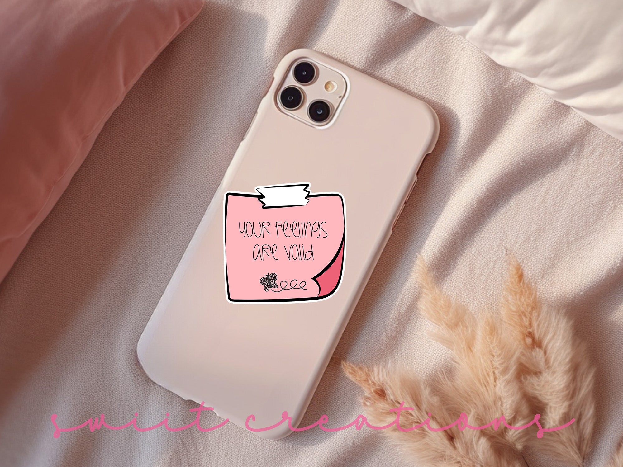 a pink phone case with a sticker on it