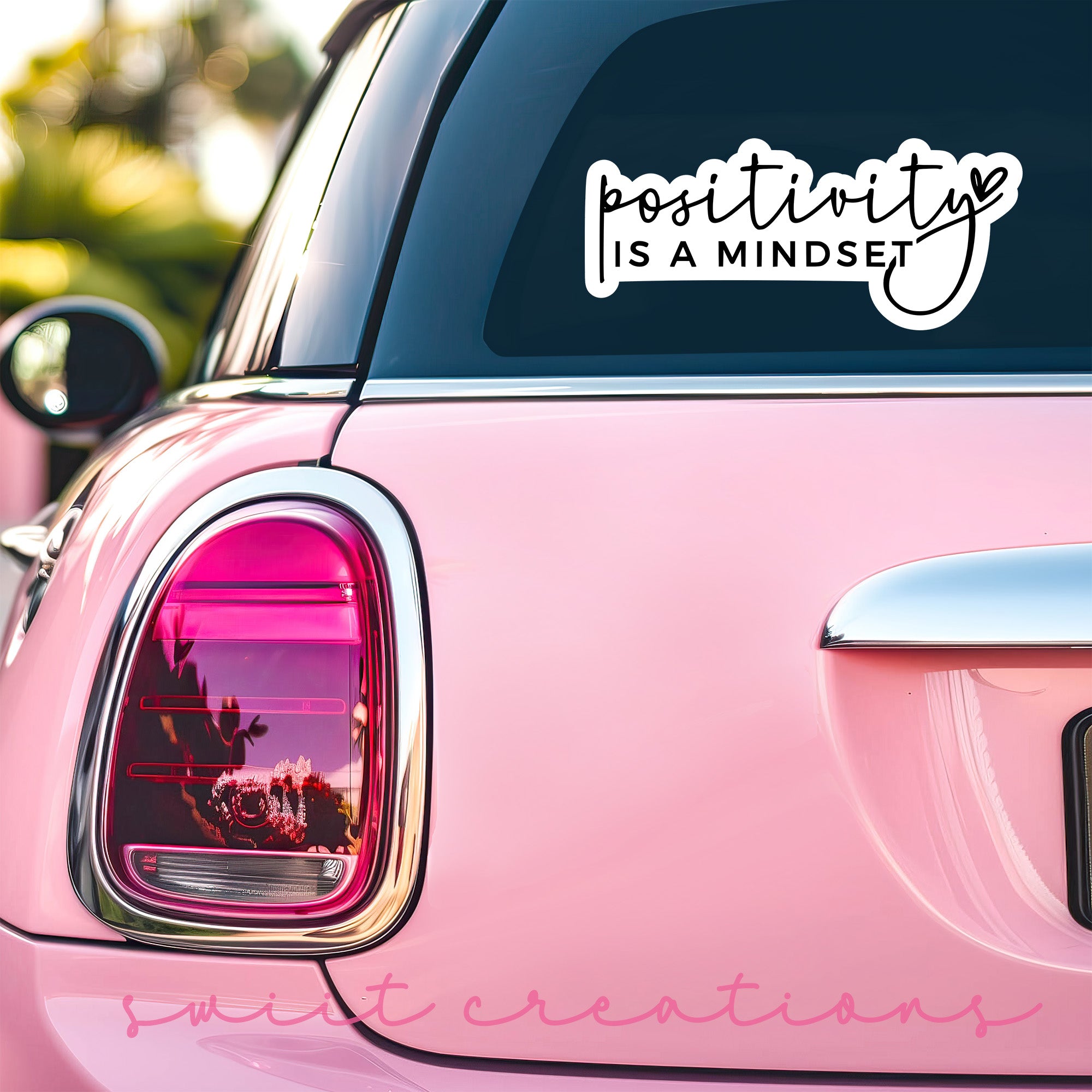 a pink car that has a sticker on it