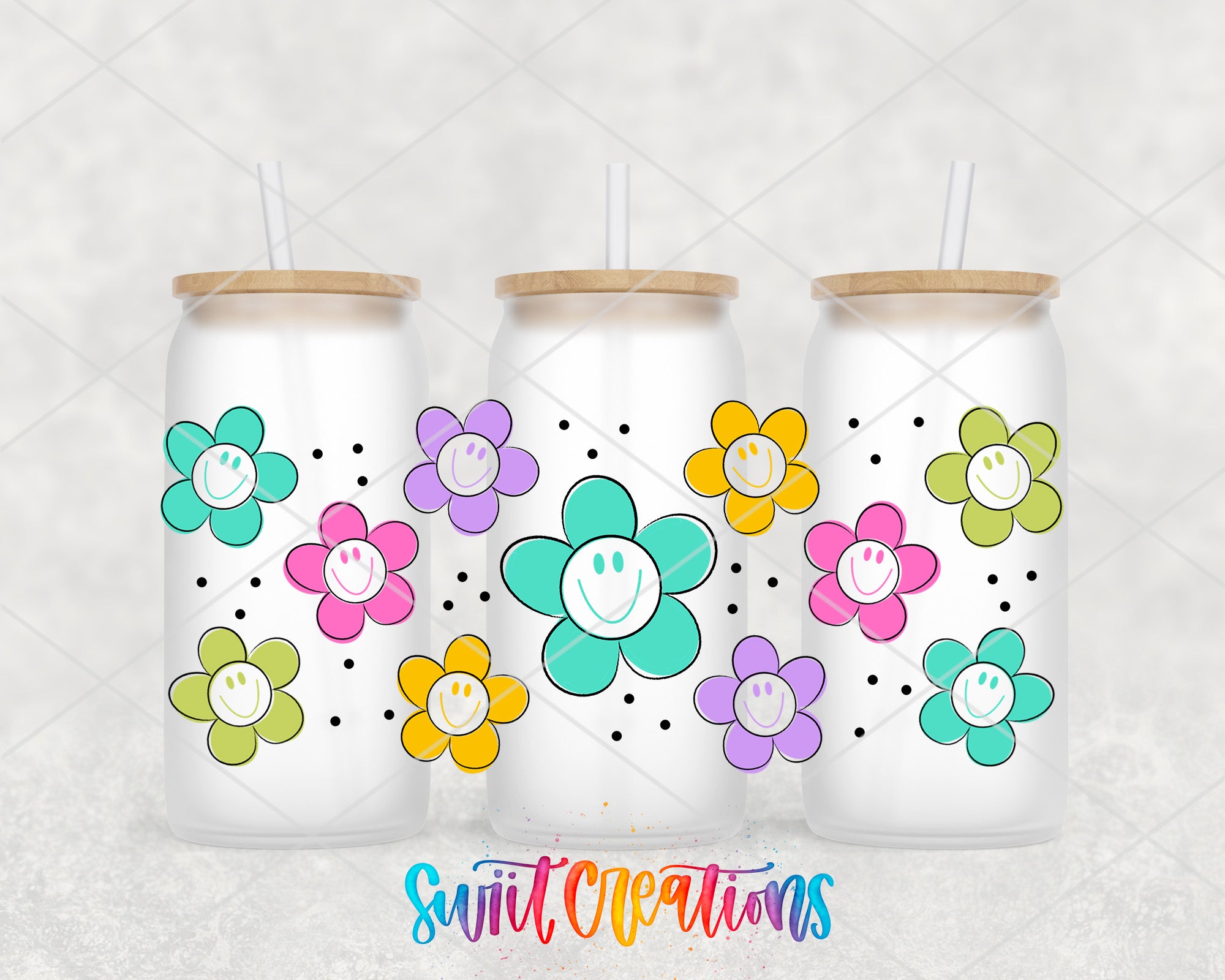 three frosted glass tumblers with colorful flower designs and straws.