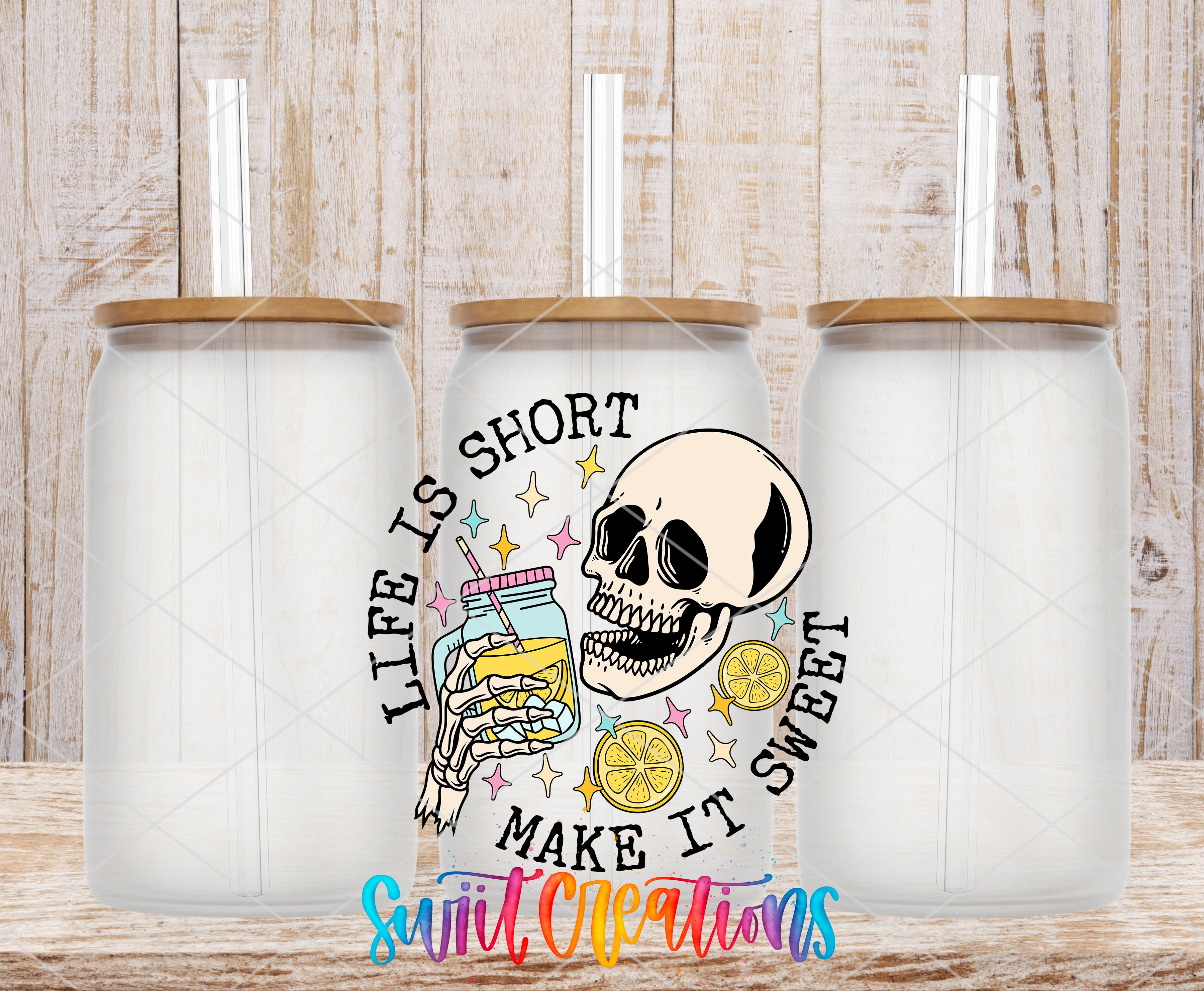 three glass jars with straws, each containing a different colored liquid, such as lemonade or orange juice. The jars are arranged in a row, and there is a skull design with a message that reads "Life is short, make it sweet" in the center of the image.