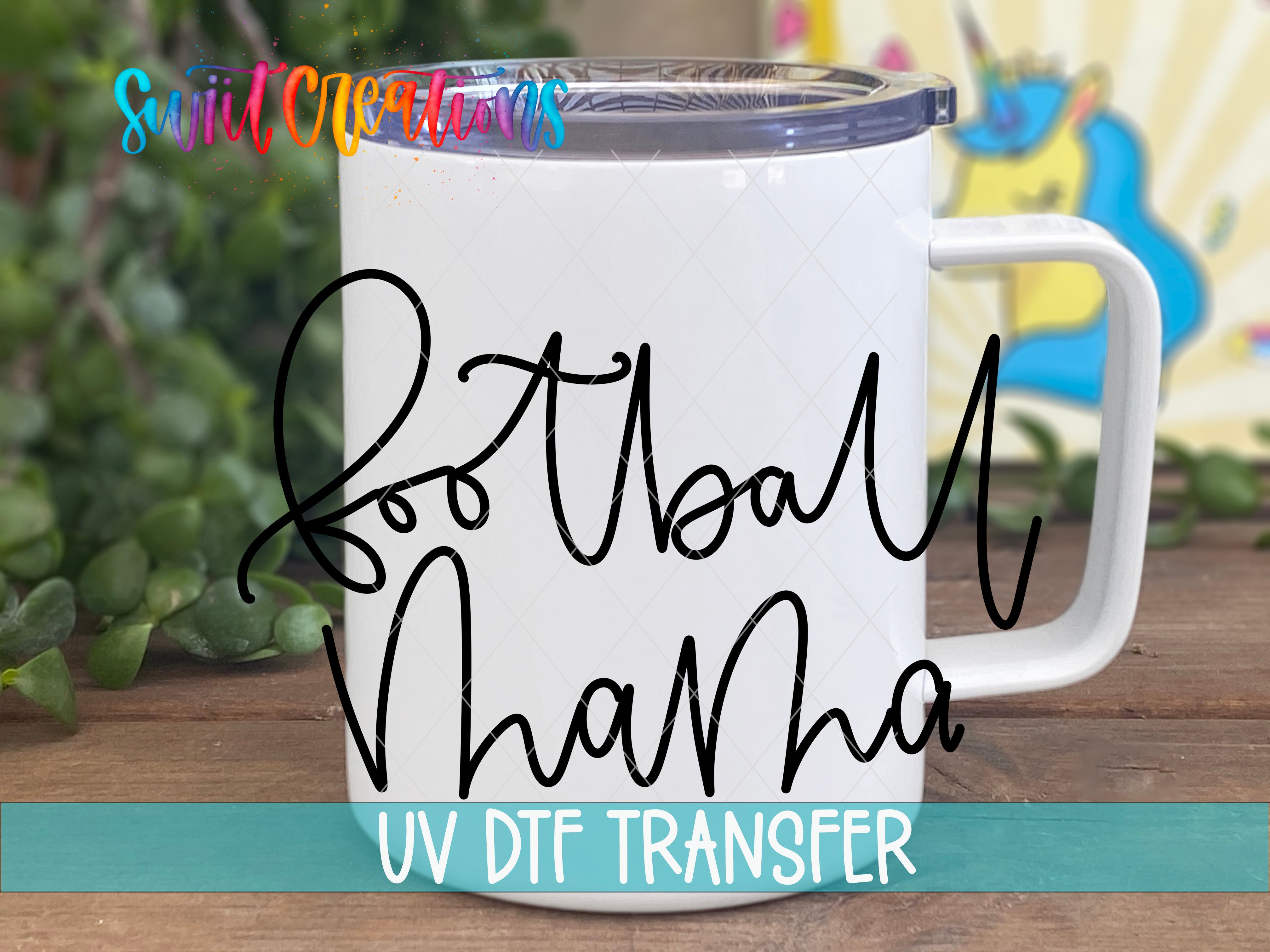 A white mug with the text "Football Vha" written on it, along with a UV DFT Transfer logo, is placed on a wooden surface.