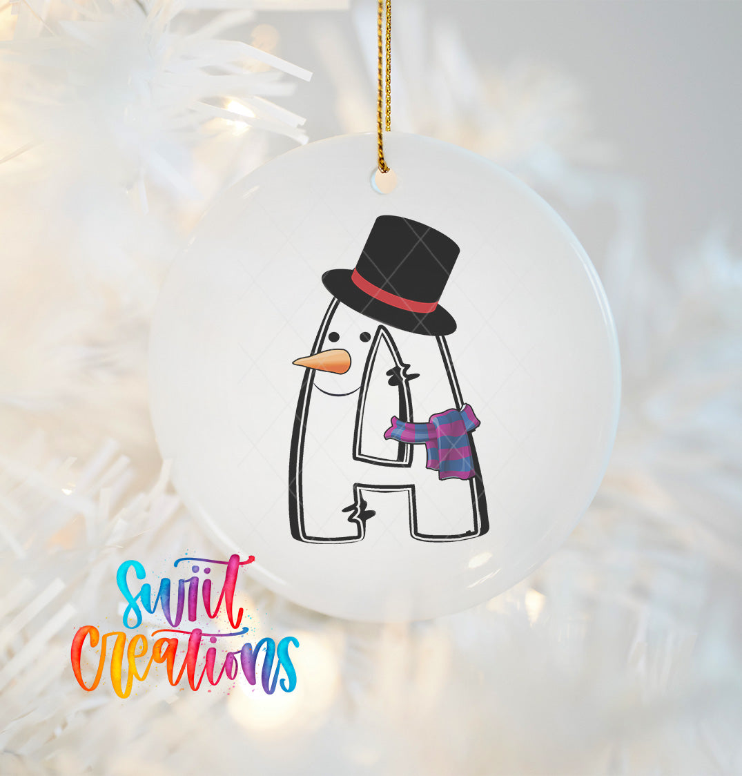A snowman ornament with a black top hat and scarf is hanging on a Christmas tree.