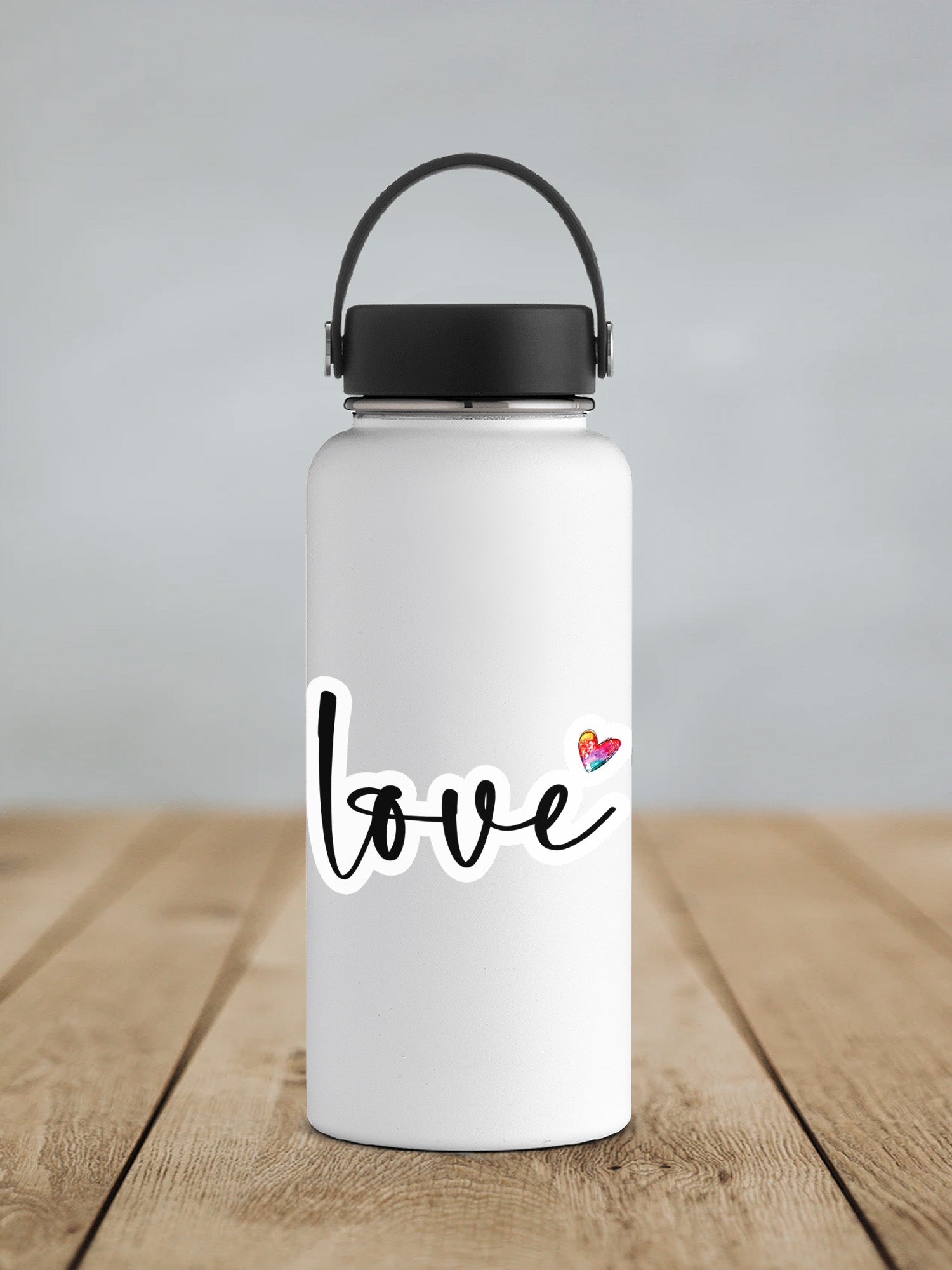 a white water bottle sitting on top of a wooden table