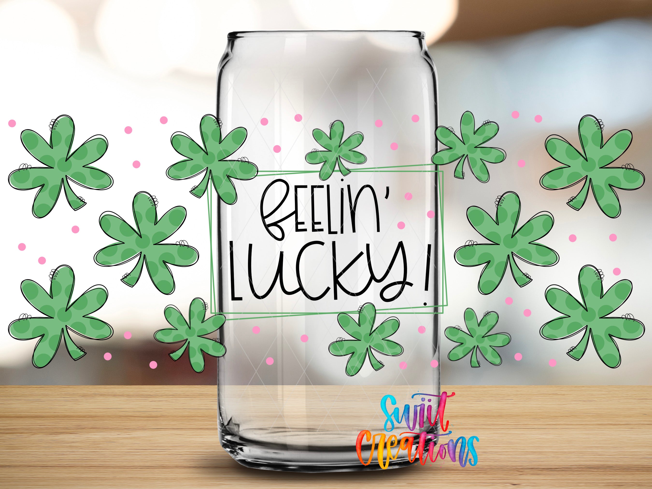 a clear glass jar with a handwritten message inside, surrounded by green shamrocks and pink dots, creating a festive and cheerful atmosphere.