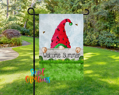 A garden gnome sign with a red hat and a green ball, surrounded by a grassy area with trees in the background.