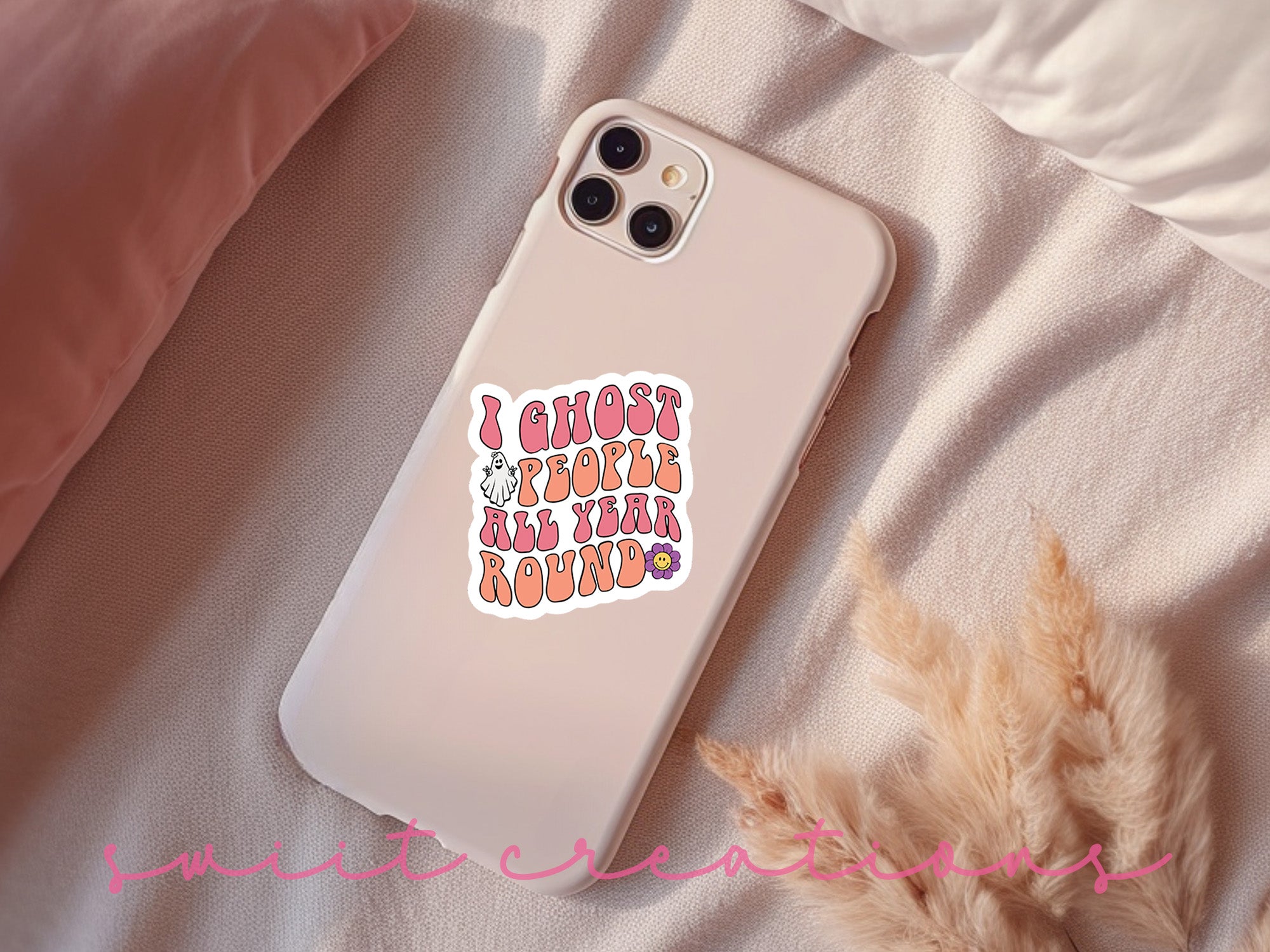 a phone case with a sticker on it sitting on a bed