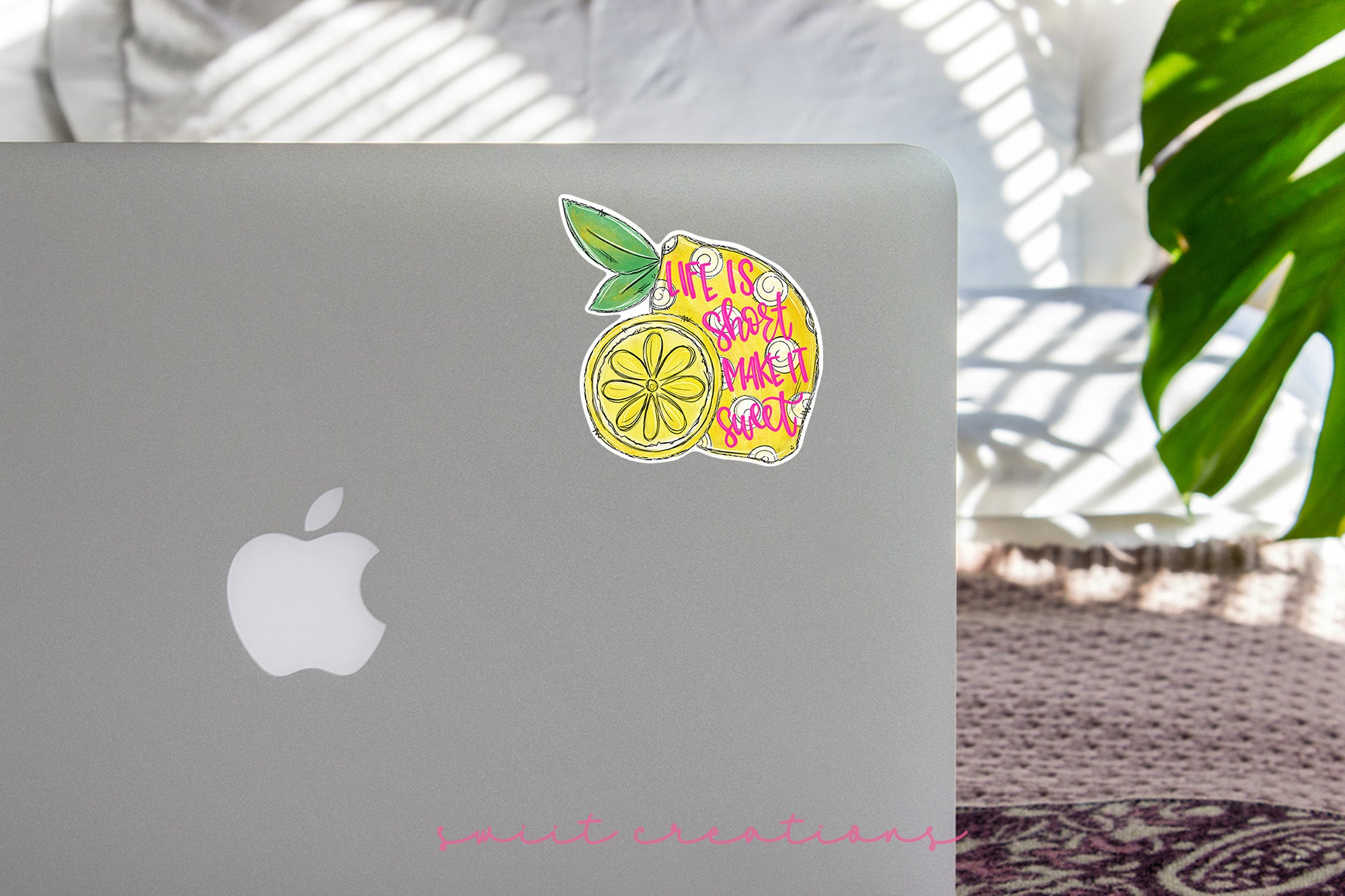 a laptop with a sticker of a lemon on it