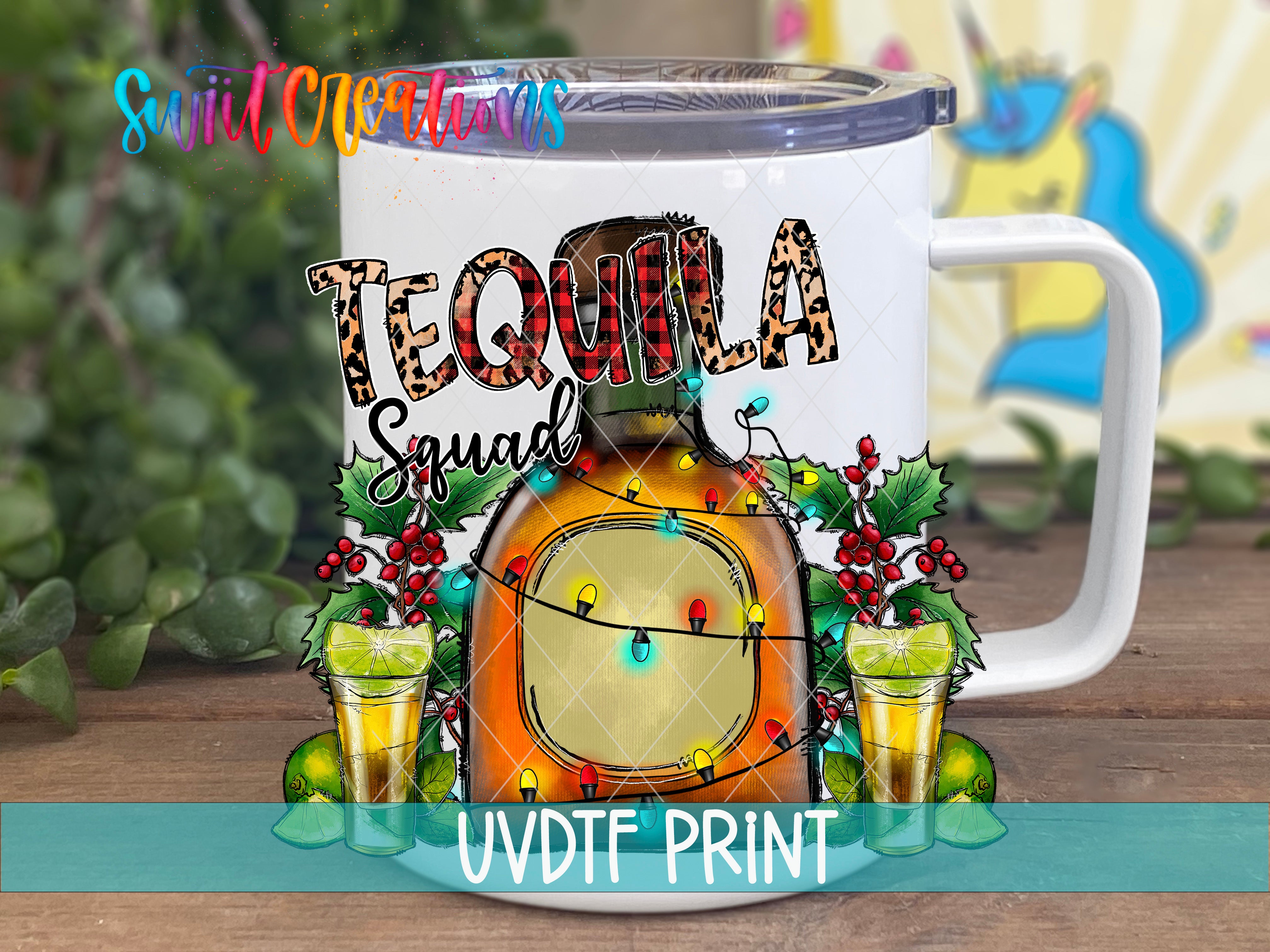 A white mug with a tequila-themed design, featuring a bottle of tequila, a lime, and a shot glass, surrounded by Christmas lights and berries.