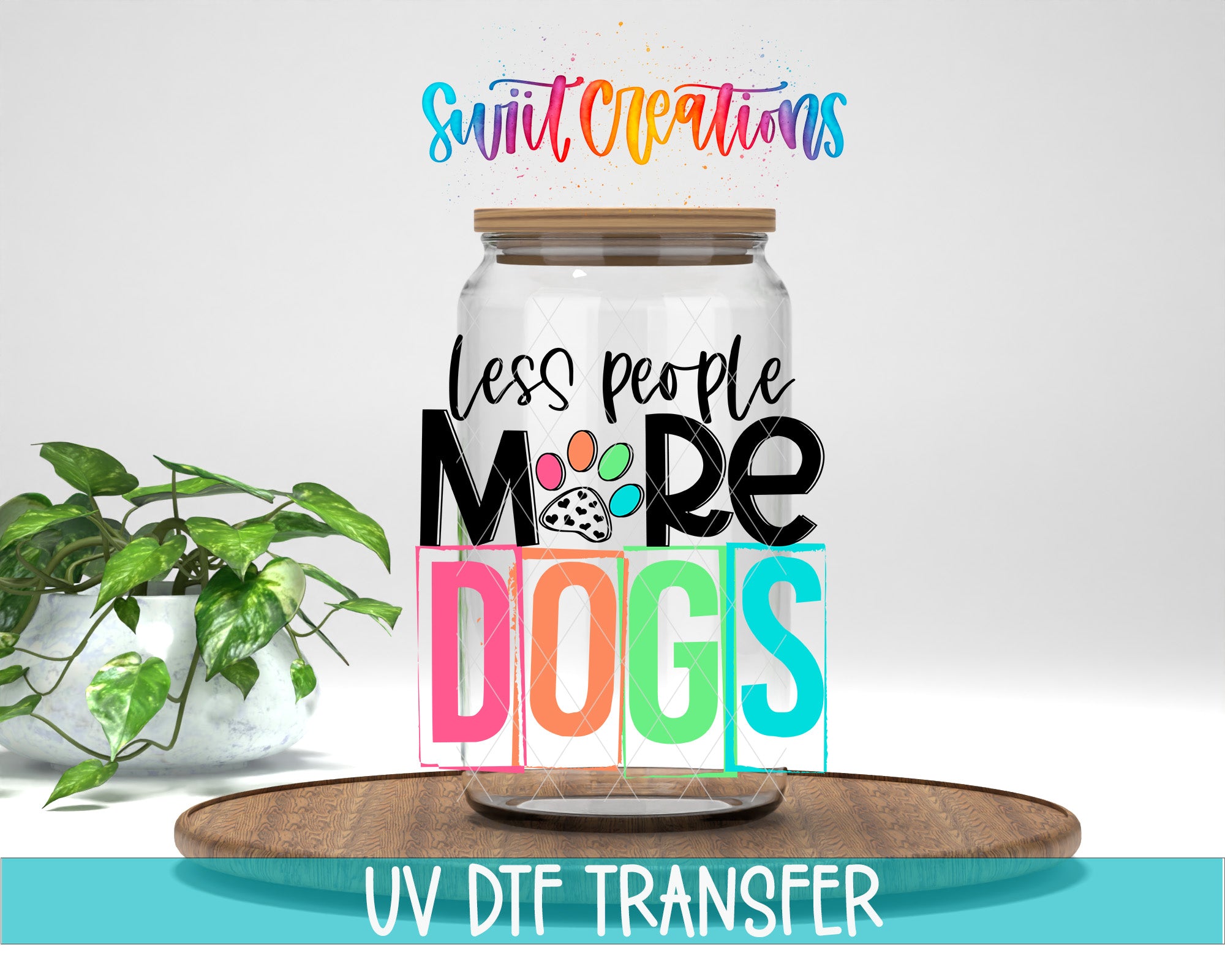 a jar with a lid, surrounded by a potted plant and a wooden tray. The text on the jar reads "less people more dogs" and "UV DFT Transfer".