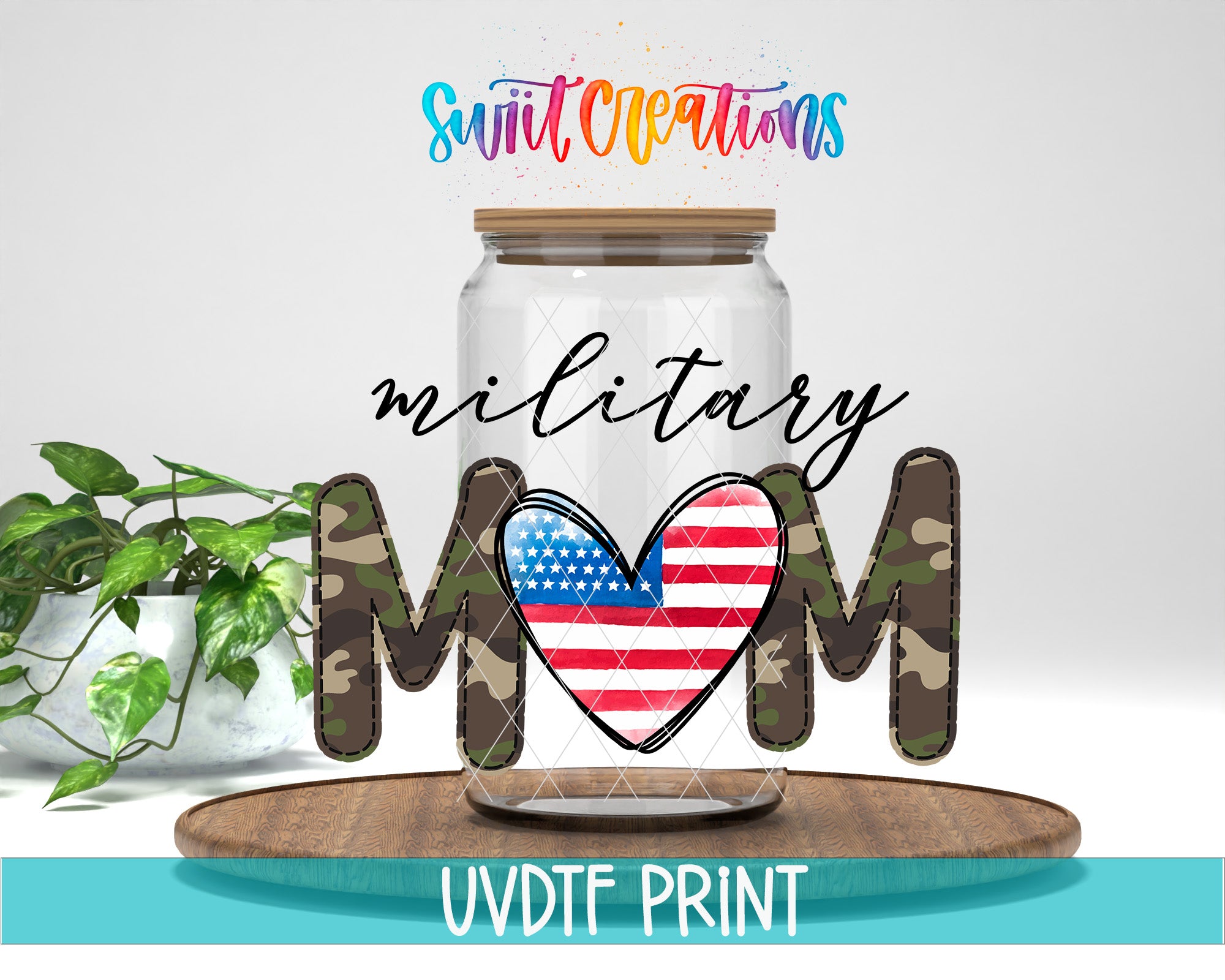 A jar with a heart-shaped design and the word "MOM" in camouflage letters, along with a plant and a wooden tray, all set against a white background.