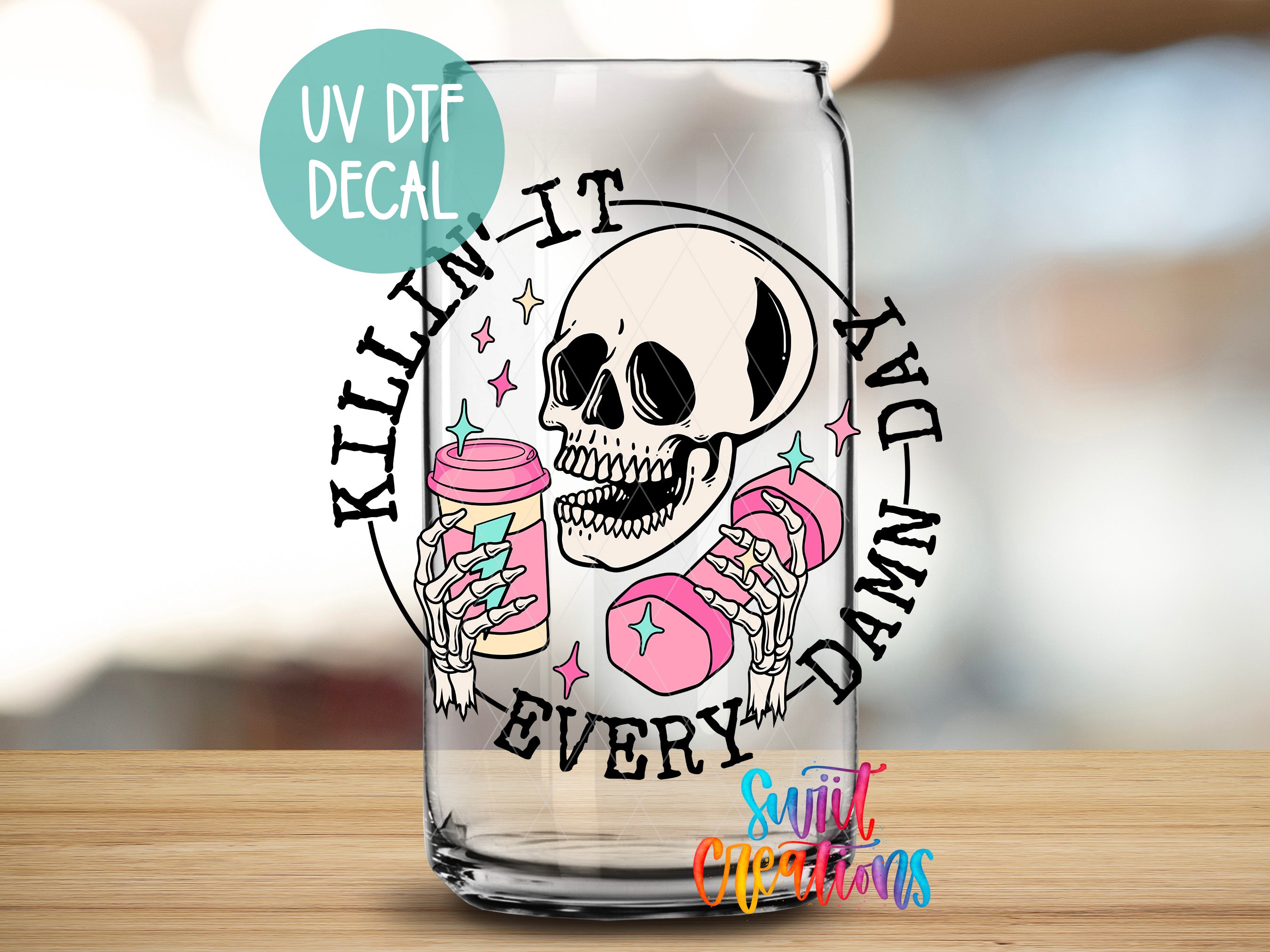 a shot glass with a skull holding a donut