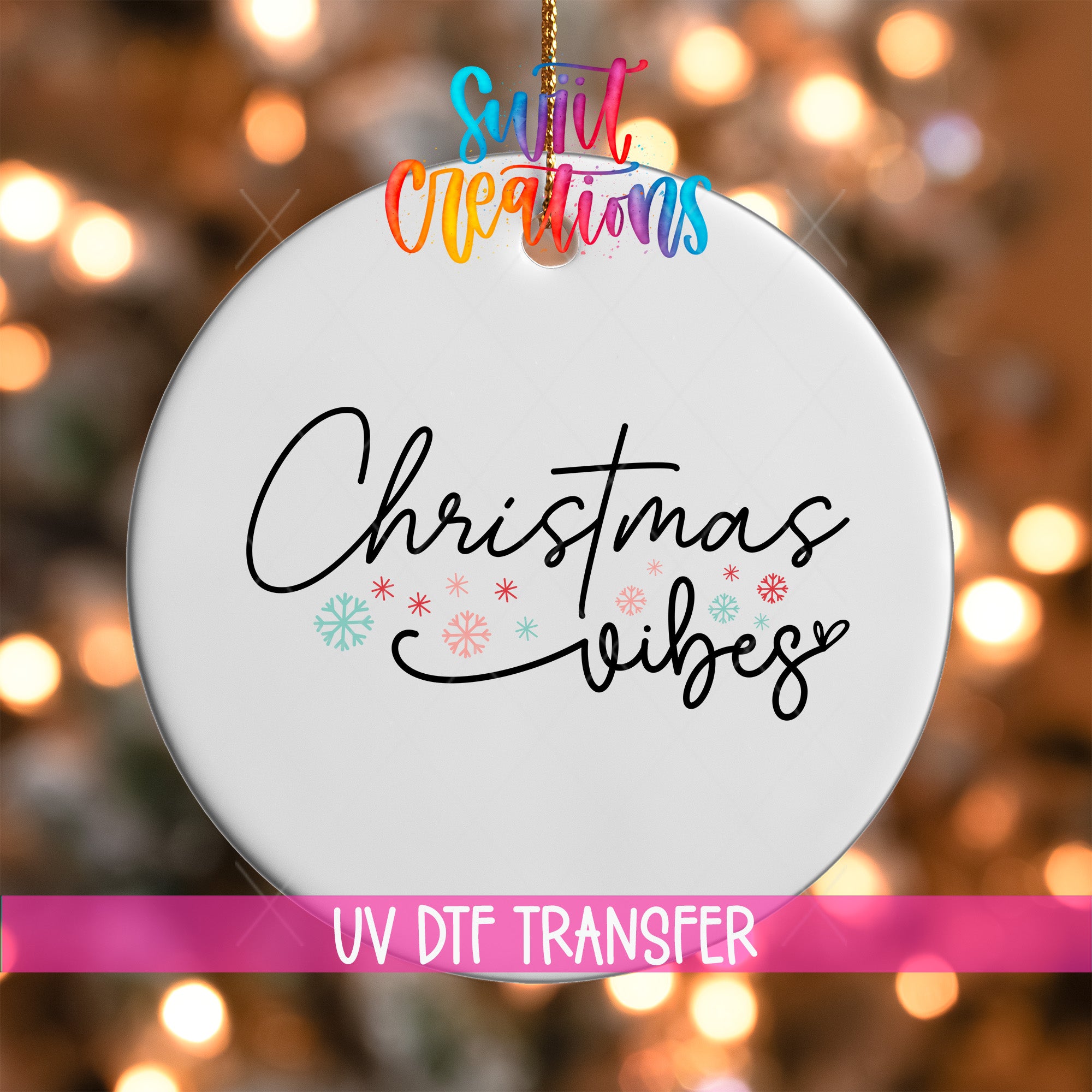 A white ornament with the text "Christmas vibes" written on it, hanging against a background of colorful lights.