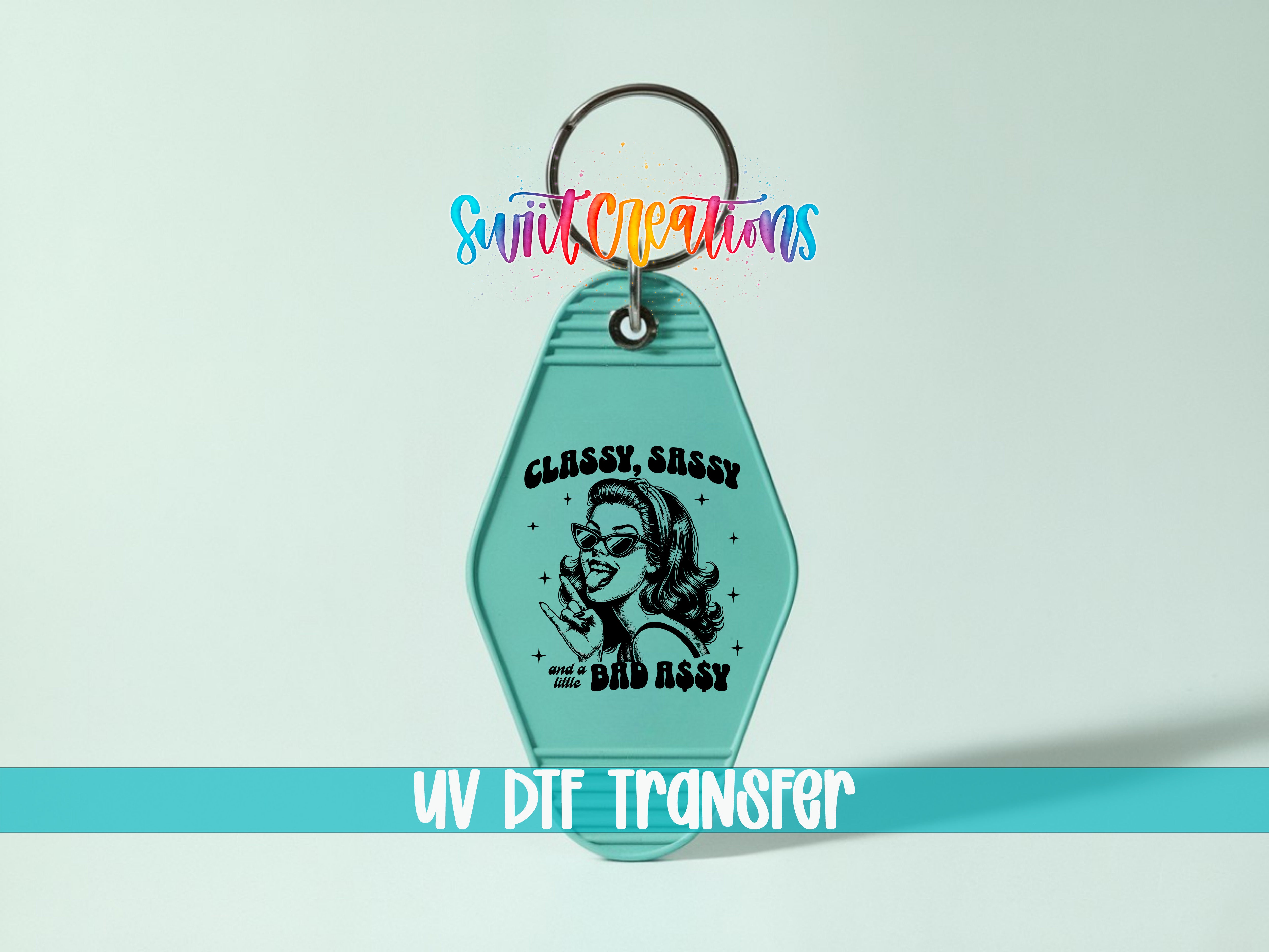 A keychain with a graphic design featuring a woman wearing sunglasses and the text "CLASSY, SASSY" and "Little Bad Ass" printed on it.