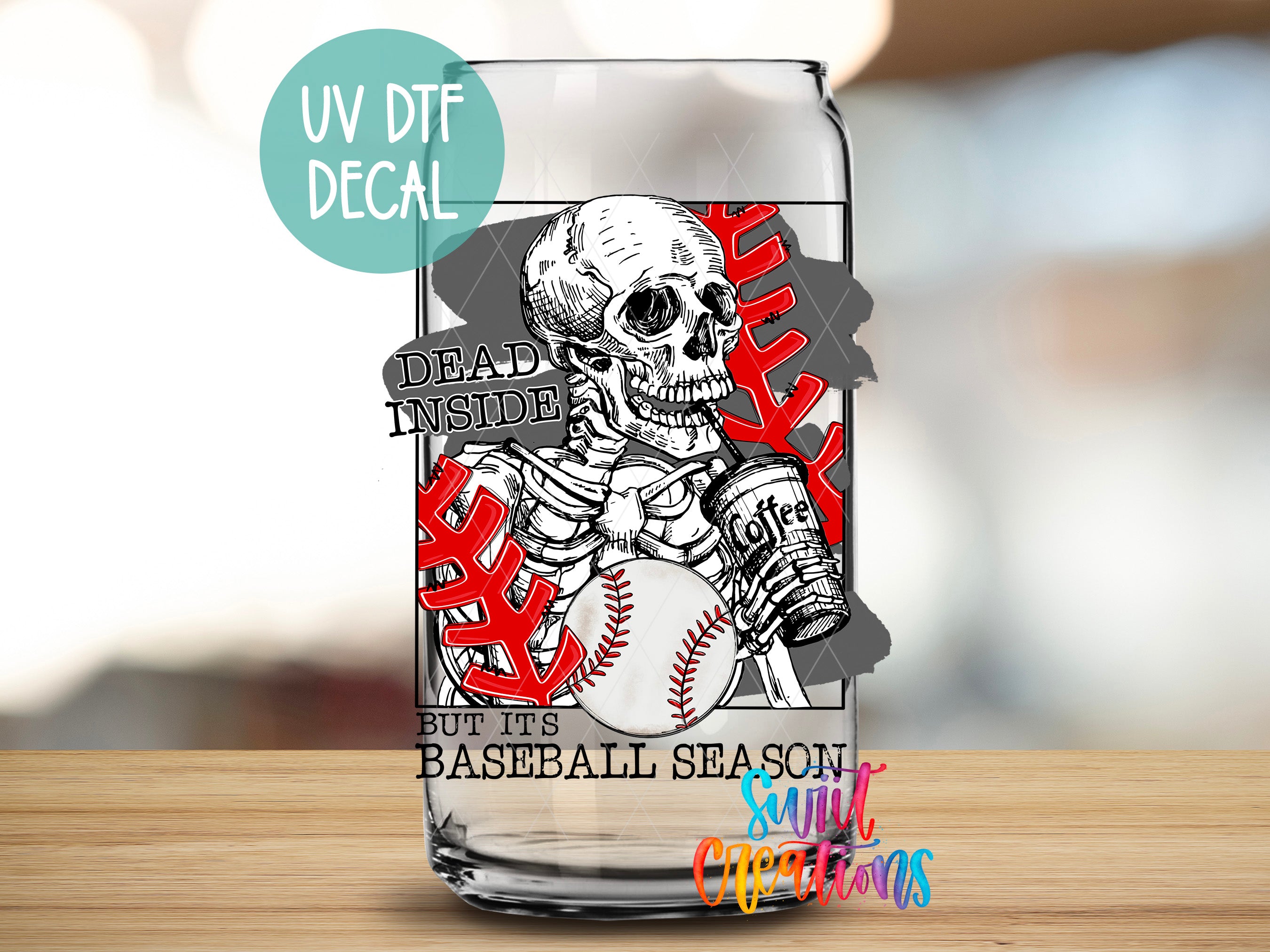 a glass with a skull holding a baseball on it